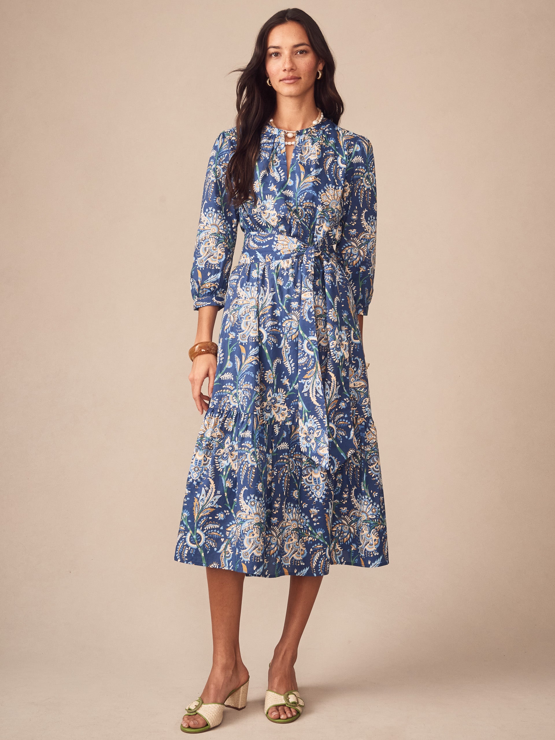A model wearing the Cerina Dress in Maxi Heirloom Paisley by J.McLaughlin, showcasing effortlessly stylish design and enduring patterns, embodying a destination for defining style. Life, Well-Lived.