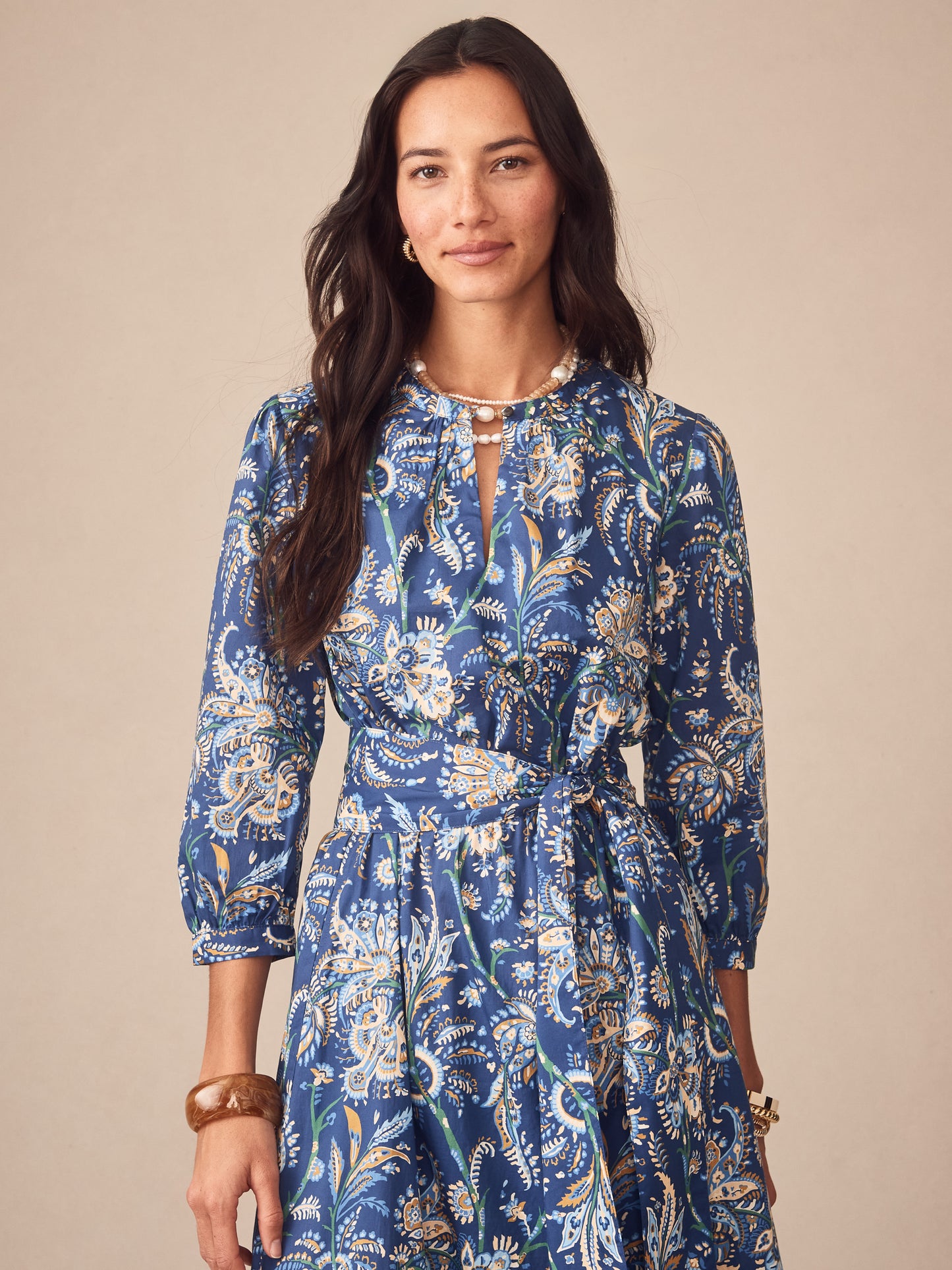 A woman wears the Cerina Dress in Maxi Heirloom Paisley by J.McLaughlin, showcasing effortlessly stylish, enduring designs with innovative fabrics for a legacy of timeless fashion. A destination for defining style. Life, Well-Lived.