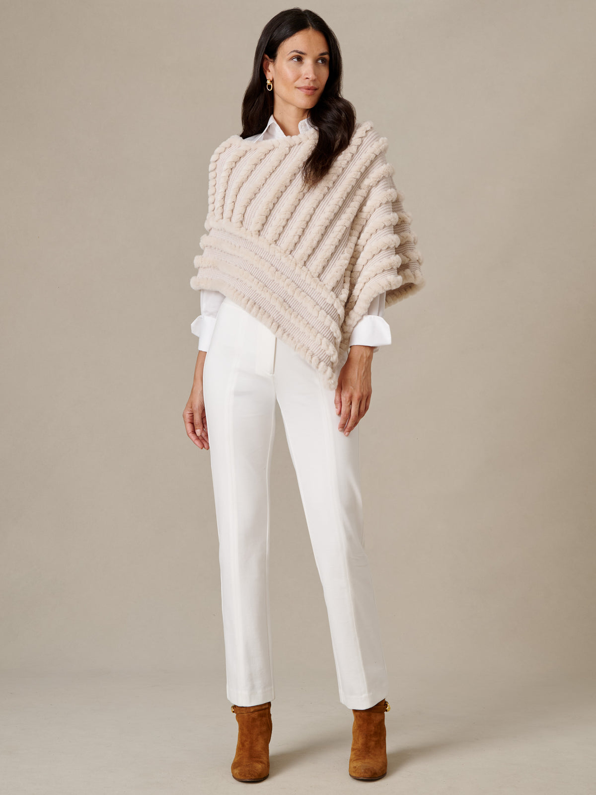 J.McLaughlin Charlie Faux Fur Poncho styled over a white blouse and pants with brown ankle boots