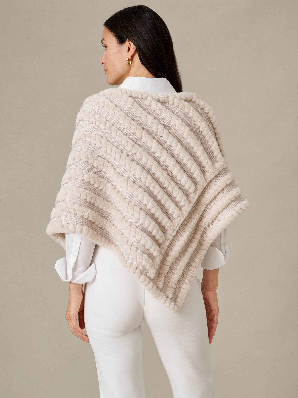 Charlie Faux Fur Poncho by J.McLaughlin shown from the back on a model in a cream textured design layered over a white blouse and pants