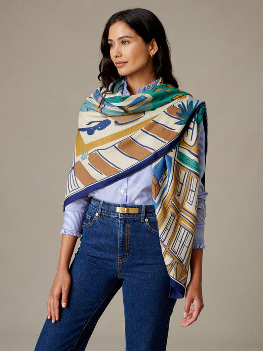 J.McLaughlin The Charlotte Scarf in Village Stroll Border worn as a colorful draped scarf with a soft cashmere silk blend and classic geometric motifs