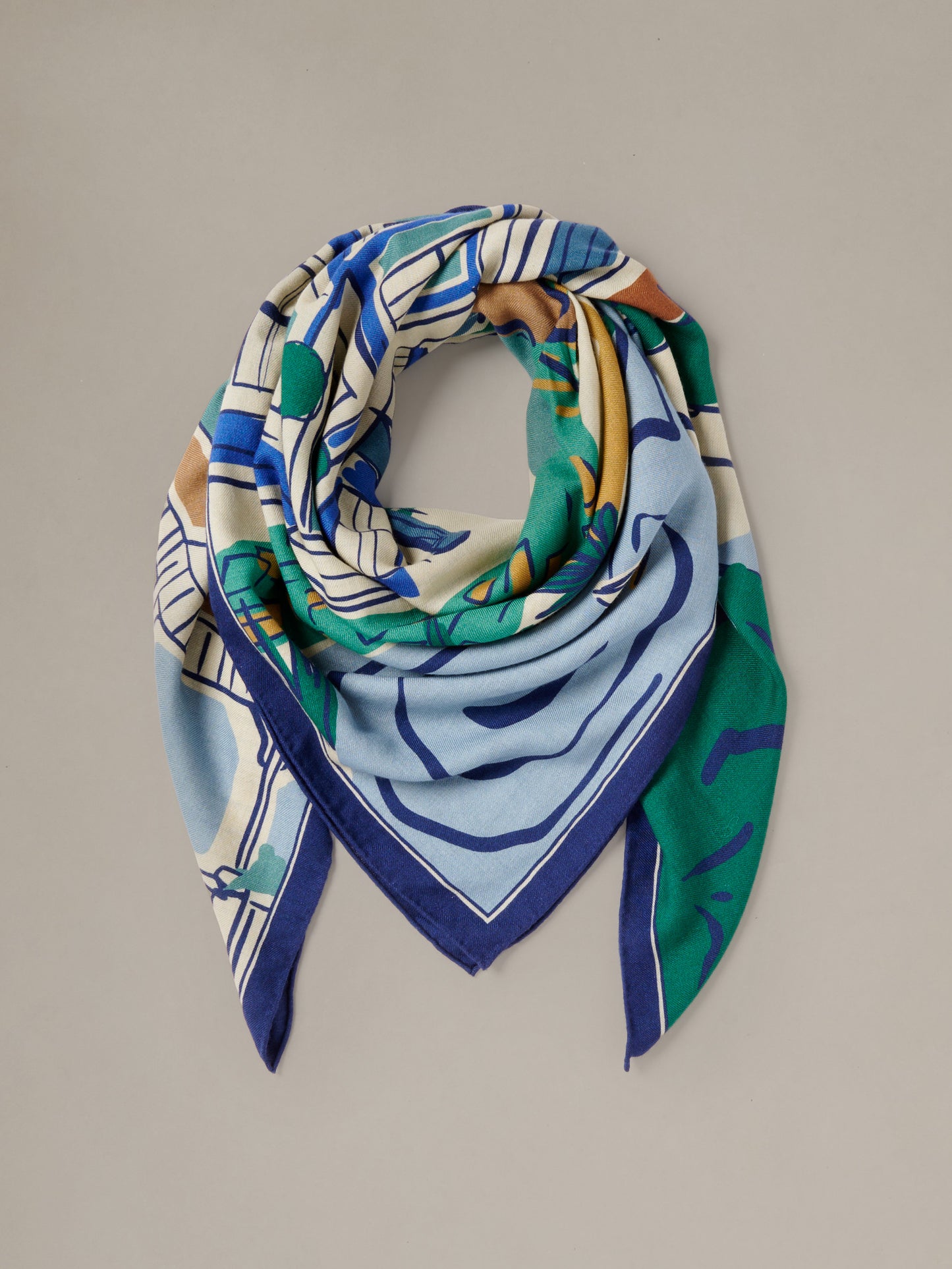 The Charlotte Scarf in Village Stroll Border by J.McLaughlin colorful cashmere silk scarf with blue green and ivory motifs draped for an elegant layered look