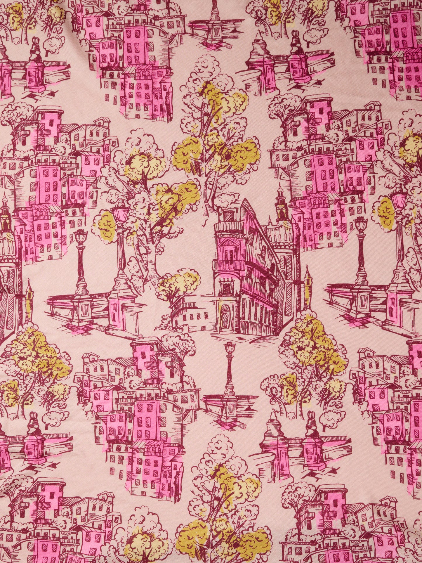 The Charlotte Scarf in Boulevard Sketch Border by J.McLaughlin featuring a soft pink cityscape border with illustrated buildings trees fountains and classic architectural details