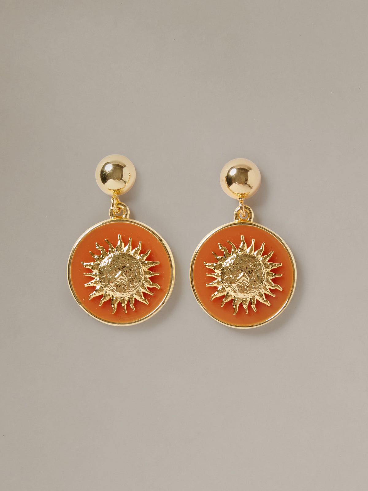 J.McLaughlin Charm Earrings with gold tone studs and amber round medallions featuring radiant sunburst details