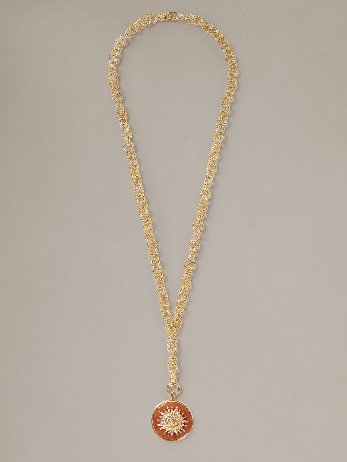 J.McLaughlin Charm Pendant Necklace featuring a delicate gold chain and round red sunburst pendant for effortlessly stylish timeless accessorizing
