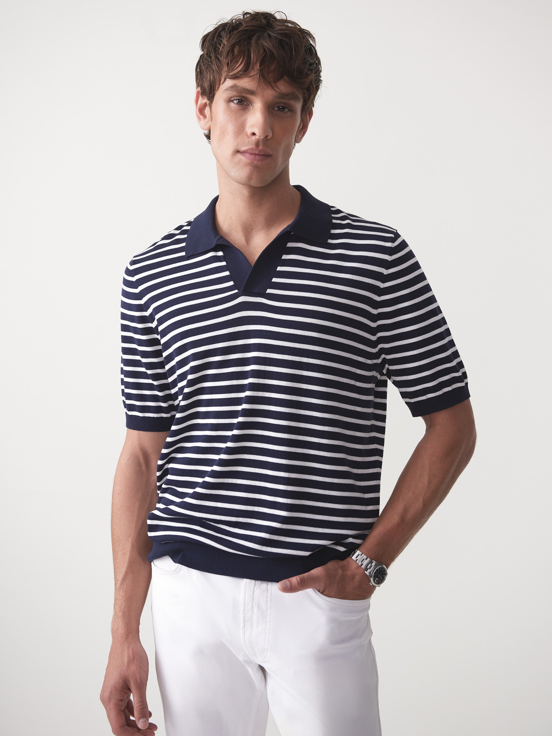 Model wearing J.McLaughlin Cillian sweater polo in navy/egret white made with cotton.