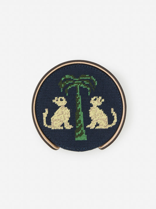 J.McLaughlin Coaster set in dark brown/khaki made with cotton needlepoint and leather.