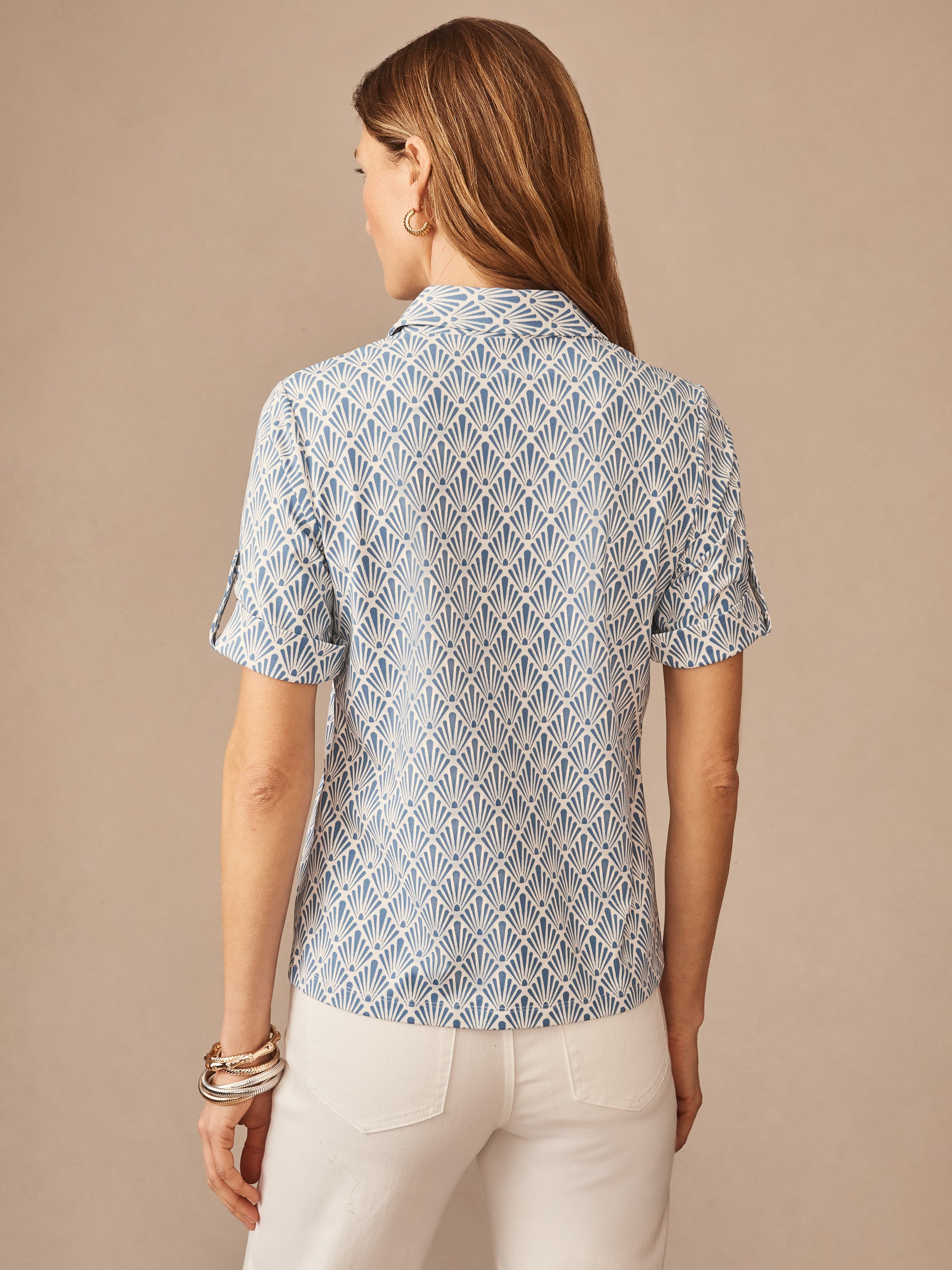A woman models the Cornelia Shirt in Sandshell by J.McLaughlin, featuring an effortlessly stylish blue and off-white patterned blouse with innovative fabrics and enduring designs for a legacy of timeless fashion. A destination for defining style. Life, Well-Lived.