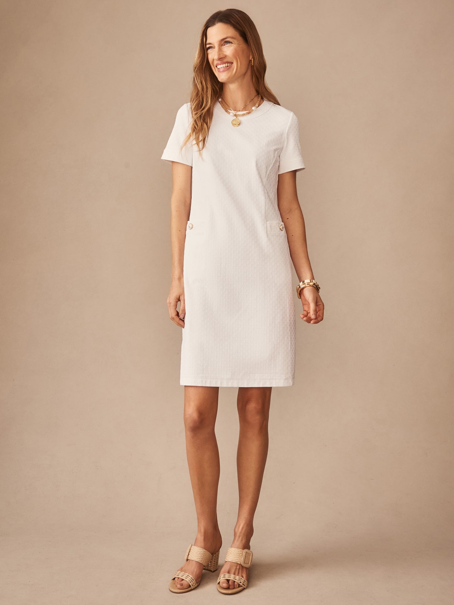 A smiling woman wearing the Daphne Dress in Dashing Jacquard by J.McLaughlin, showcasing effortlessly stylish, enduring designs with innovative fabrics in a timeless look.