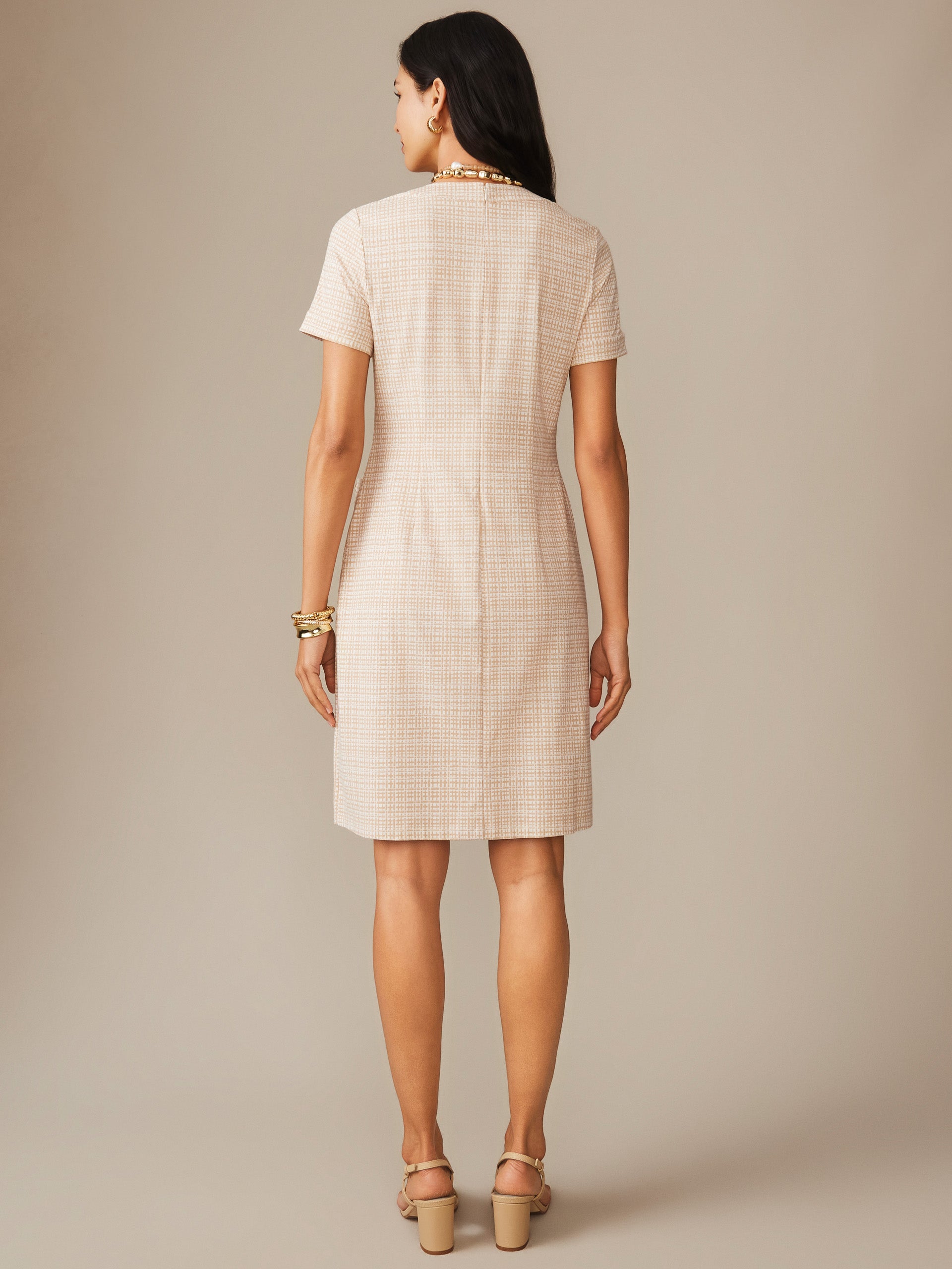 Woman wearing a Daphne Dress in Pocket Square by J.McLaughlin, featuring a classic off-white and tan plaid pattern, showcasing effortlessly stylish, enduring designs and innovative fabrics.