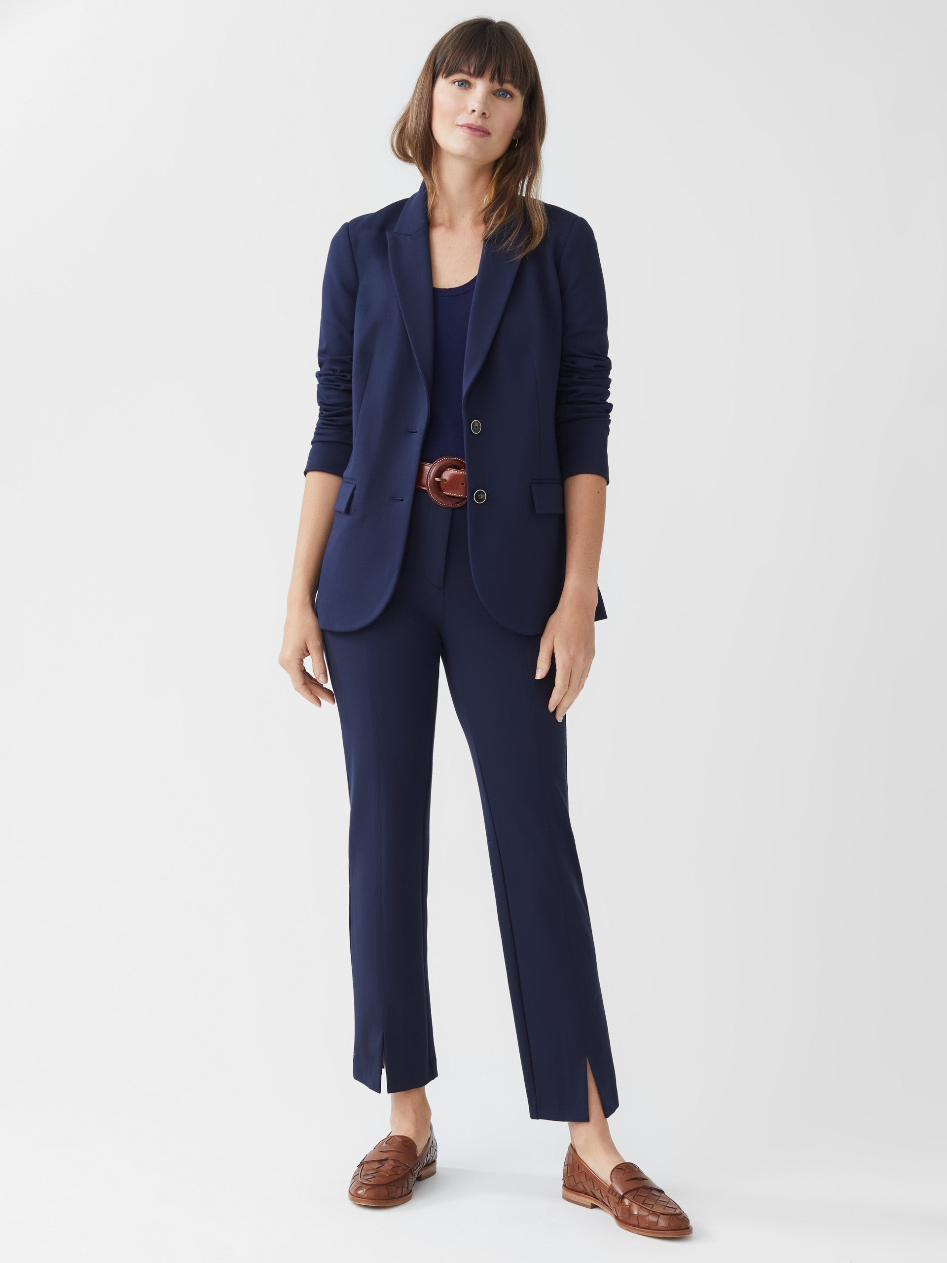 Model wearing J.McLaughlin Deanne pants in winter navy made with bainbridge fabric.