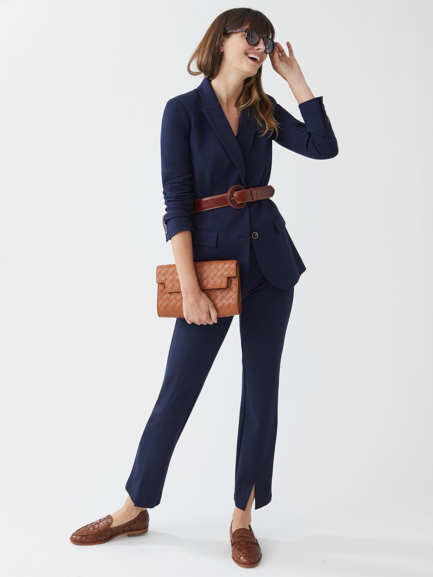 Model wearing J.McLaughlin Deanne pants in winter navy made with bainbridge fabric.