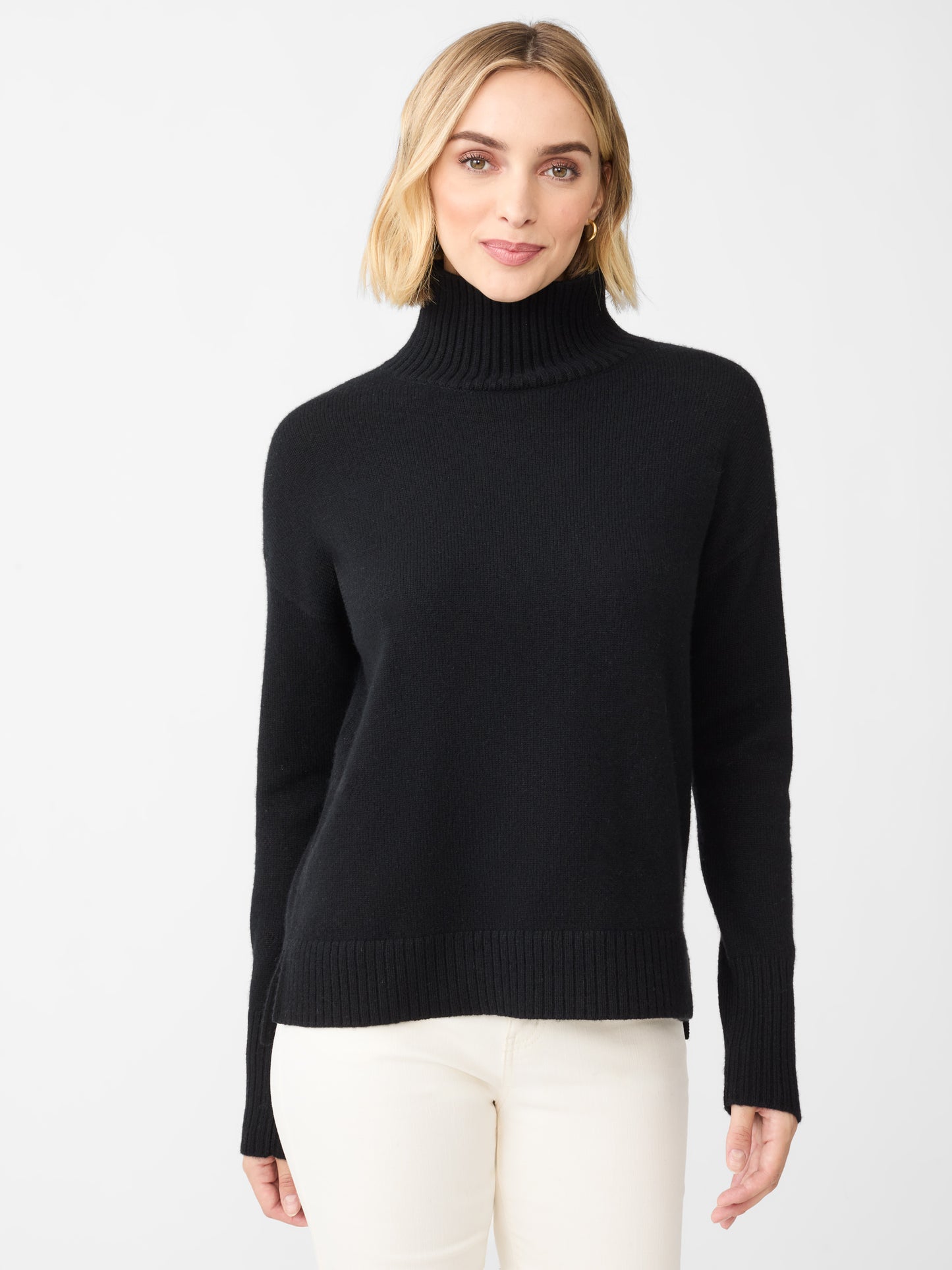 Model wearing J.McLaughlin Dina turtleneck in black made with cashmere.