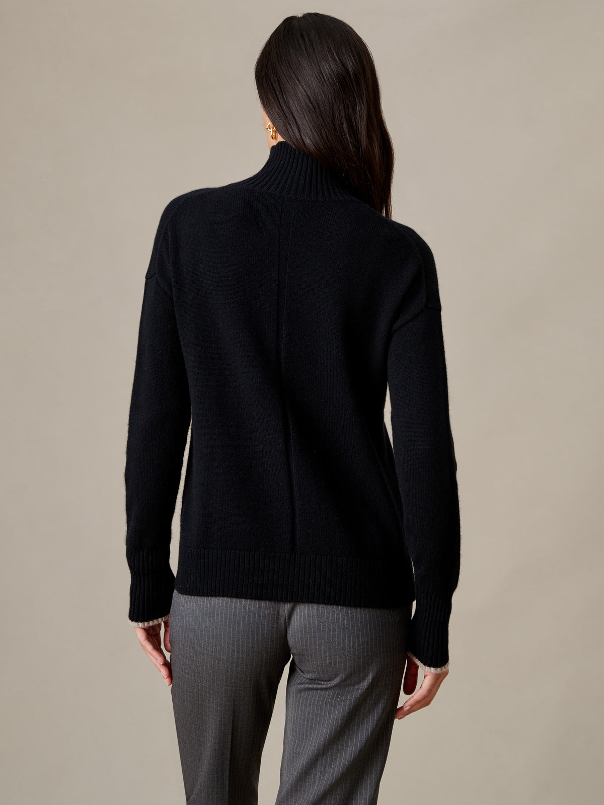 J.McLaughlin Dina Cashmere Turtleneck in black cashmere shown from the back with gray pants