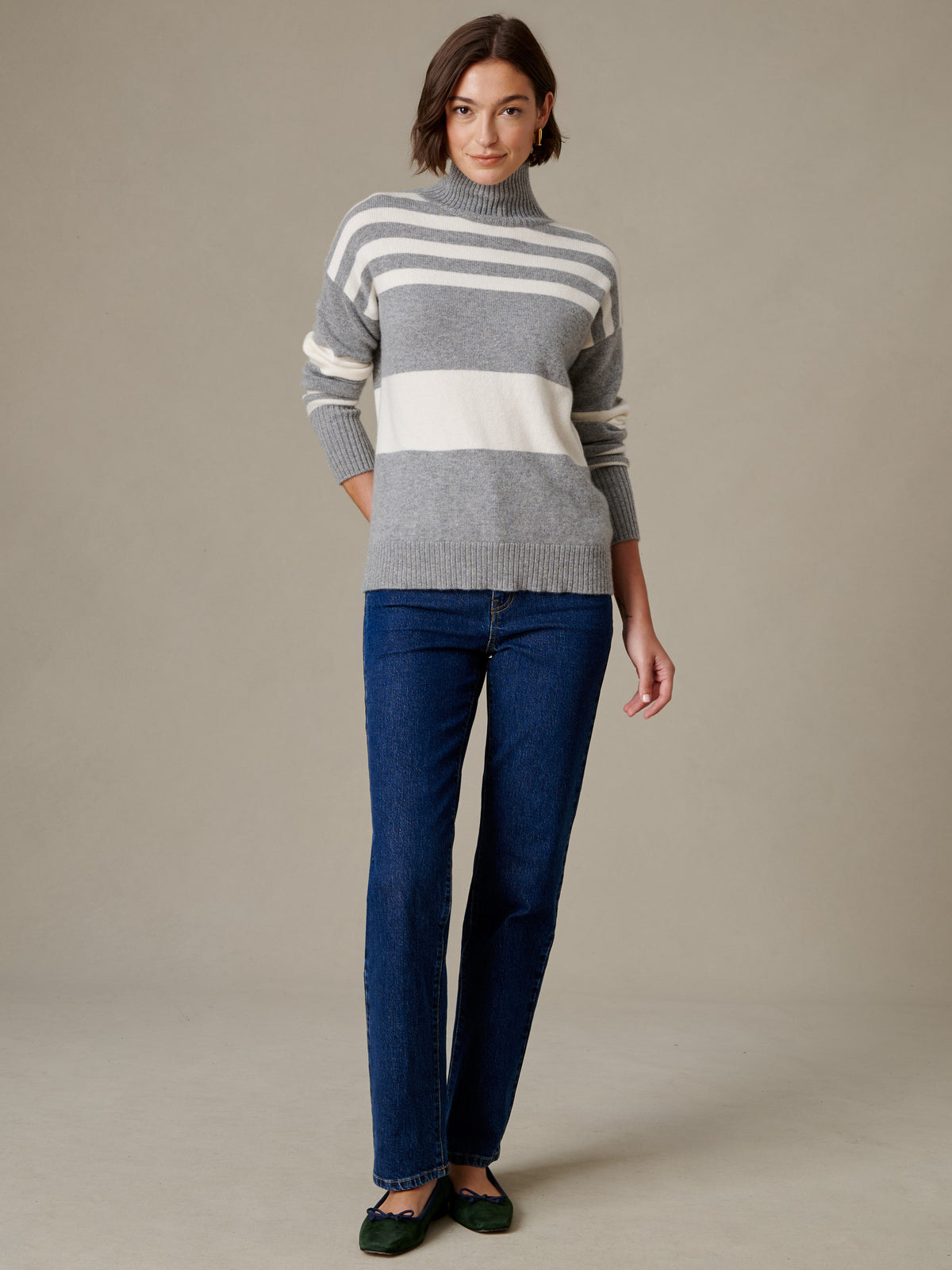 J.McLaughlin Dina Cashmere Turtleneck in Stripe modeled with dark jeans and loafers in a timeless casual look