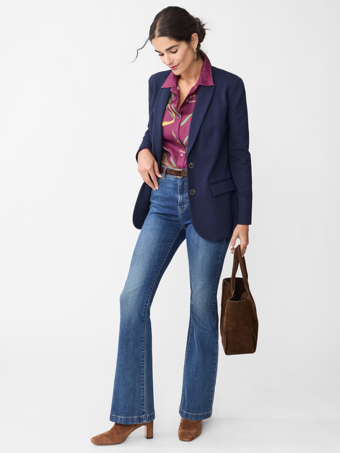 Model wearing J.McLaughlin Domino jeans in dark indigo made with woven denim.