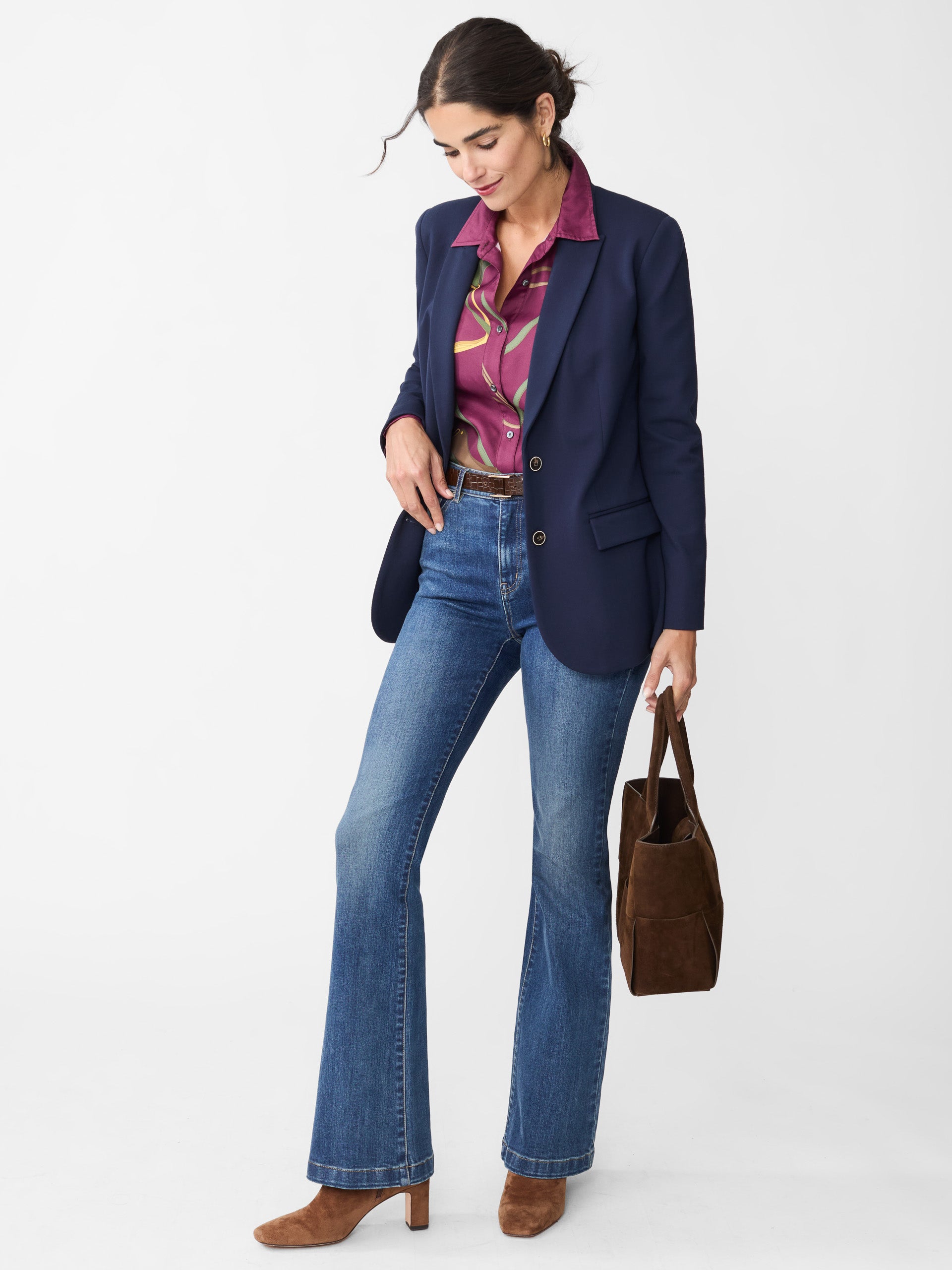Model wearing J.McLaughlin Domino jeans in dark indigo made with woven denim.