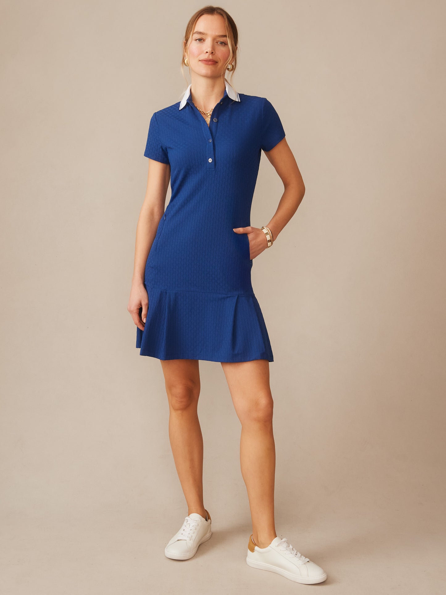 Woman wearing a blue Dorte Dress in Dashing Jacquard by J.McLaughlin, featuring a classic collar and short sleeves, styled with casual white sneakers, effortlessly stylish with enduring designs and innovative fabrics. A destination for defining style. Life, Well-Lived.