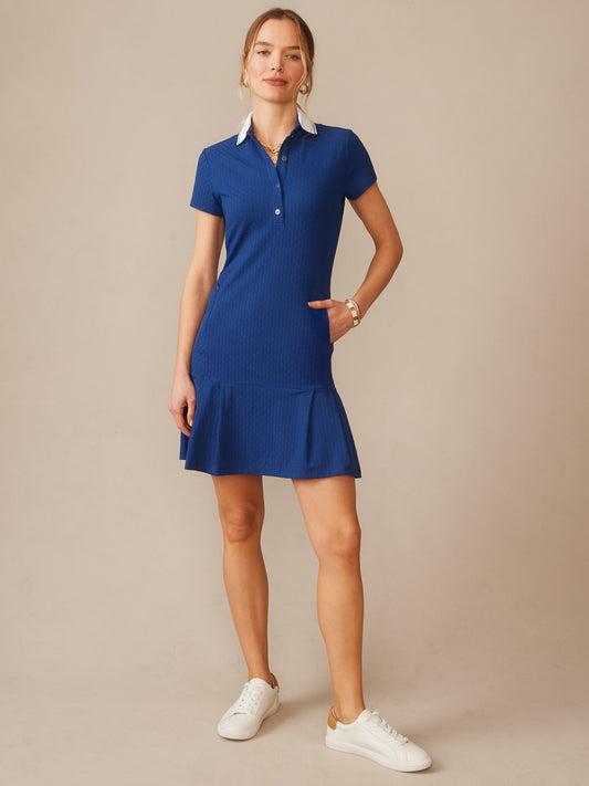 Woman wearing a blue Dorte Dress in Dashing Jacquard by J.McLaughlin, featuring a classic collar and short sleeves, styled with casual white sneakers, effortlessly stylish with enduring designs and innovative fabrics. A destination for defining style. Life, Well-Lived.