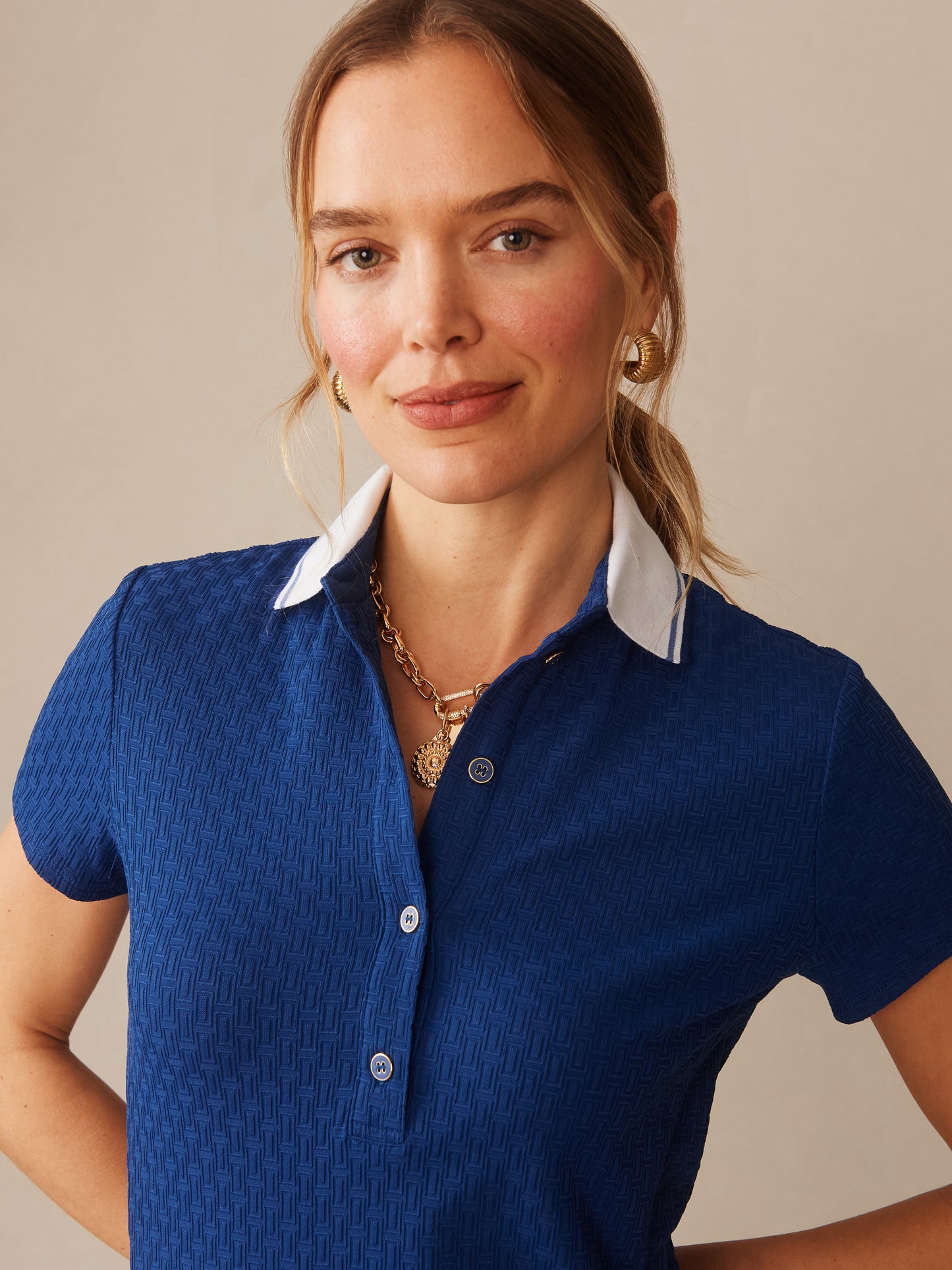 Close-up of a woman wearing the Dorte Dress in Dashing Jacquard by J.McLaughlin, featuring a navy textured fabric with a white collar, embodying effortlessly stylish, enduring designs and innovative fabrics from a destination for defining style. Life, Well-Lived.