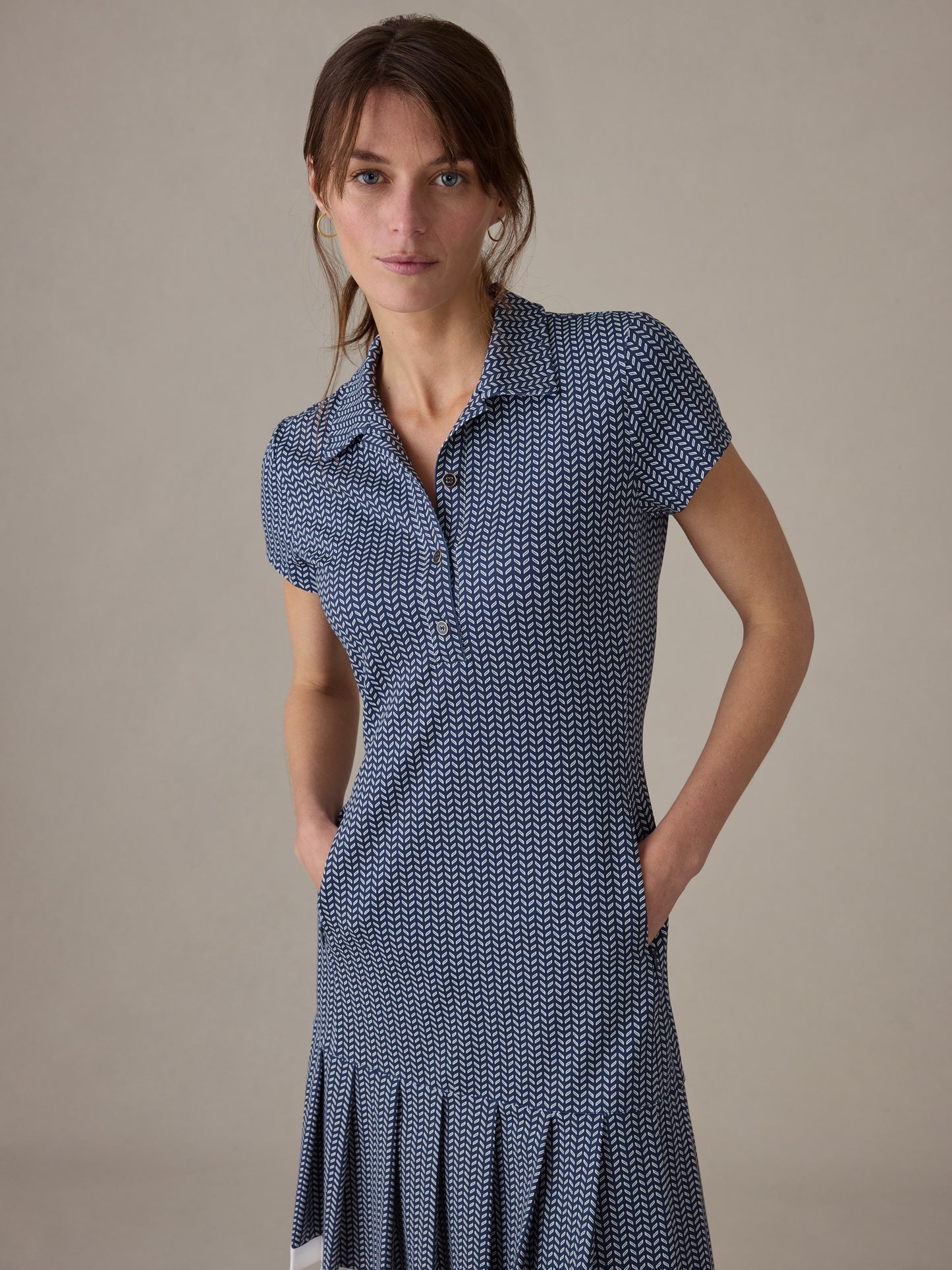 Woman wearing a J.McLaughlin Dorte Dress in Vine with short sleeves and a subtle geometric pattern, showcasing timeless style and impeccable craftsmanship.