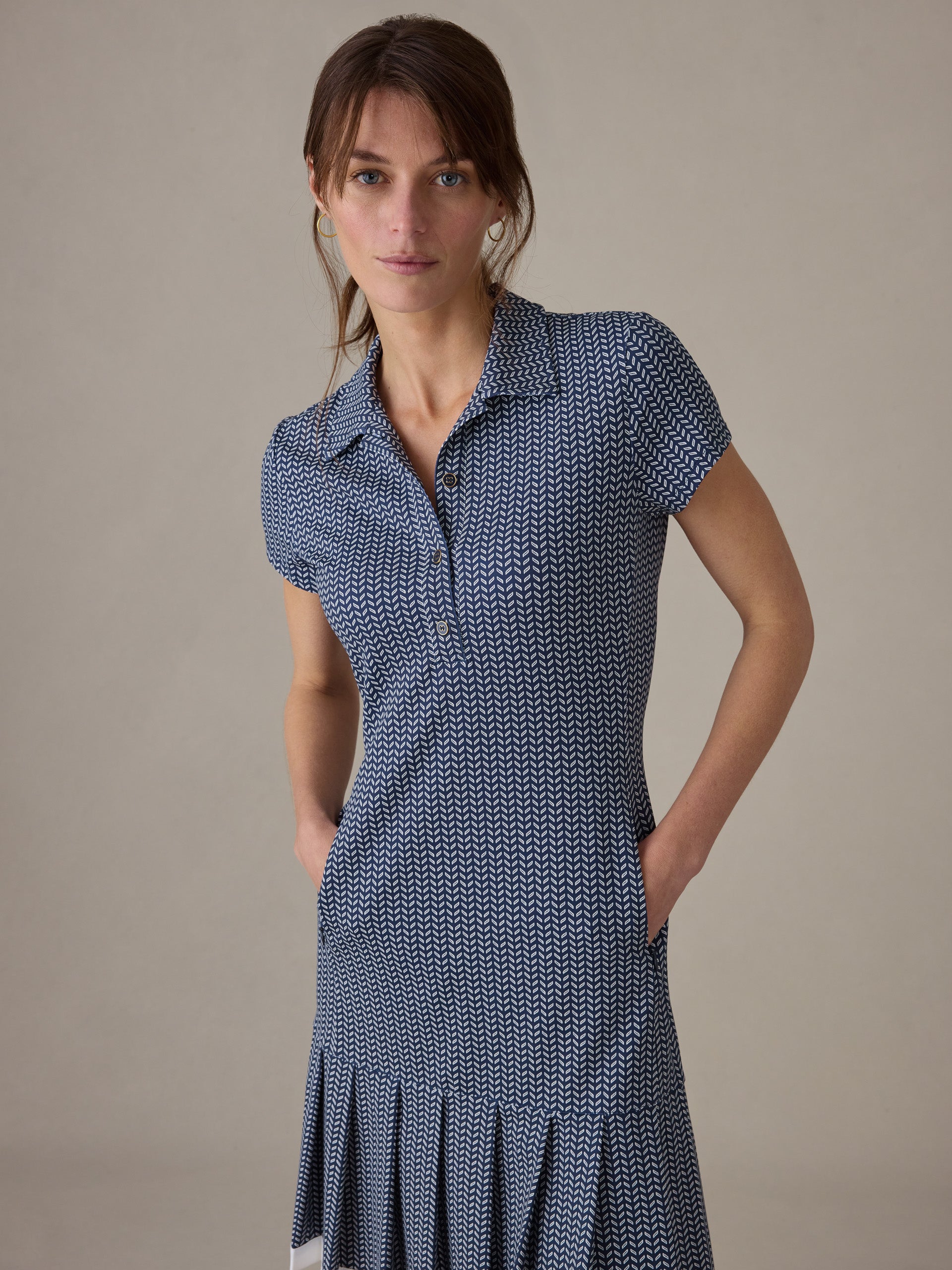 Woman wearing a J.McLaughlin Dorte Dress in Vine with short sleeves and a subtle geometric pattern, showcasing timeless style and impeccable craftsmanship.