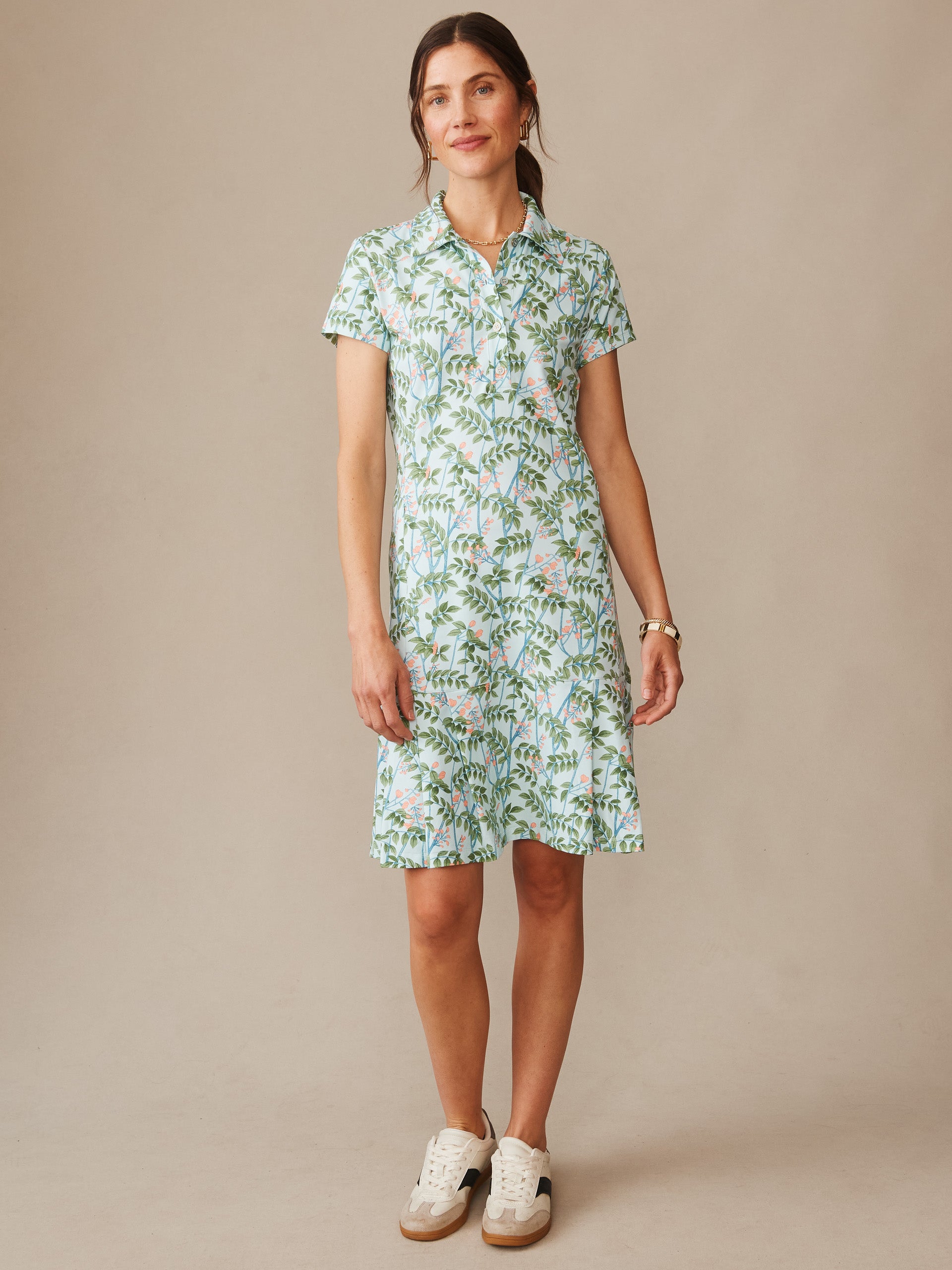 Woman wearing J.McLaughlin’s Dorte Dress in Neo Blooming Vines, showcasing effortlessly stylish, enduring designs with a floral print in soft blue and green, embodying a legacy of timeless fashion. A destination for defining style. Life, Well-Lived.