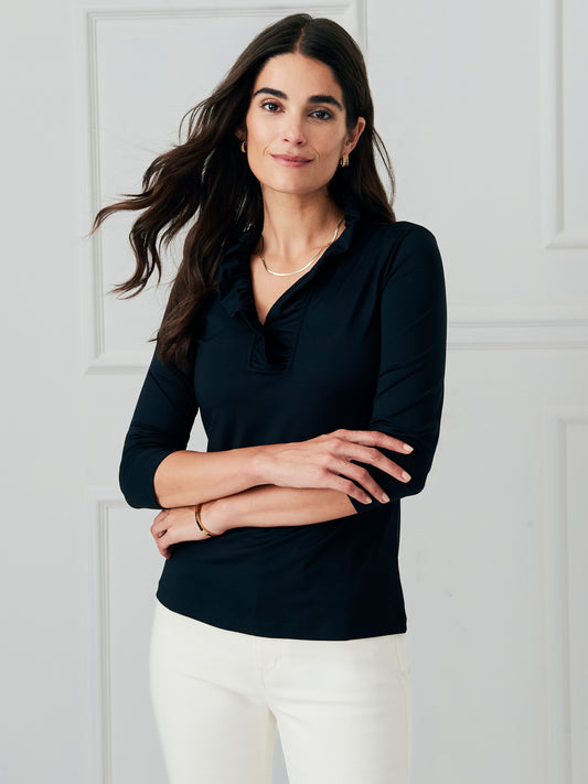 Model wearing J.McLaughlin Durham ruffle top in black made with Catalina cloth.