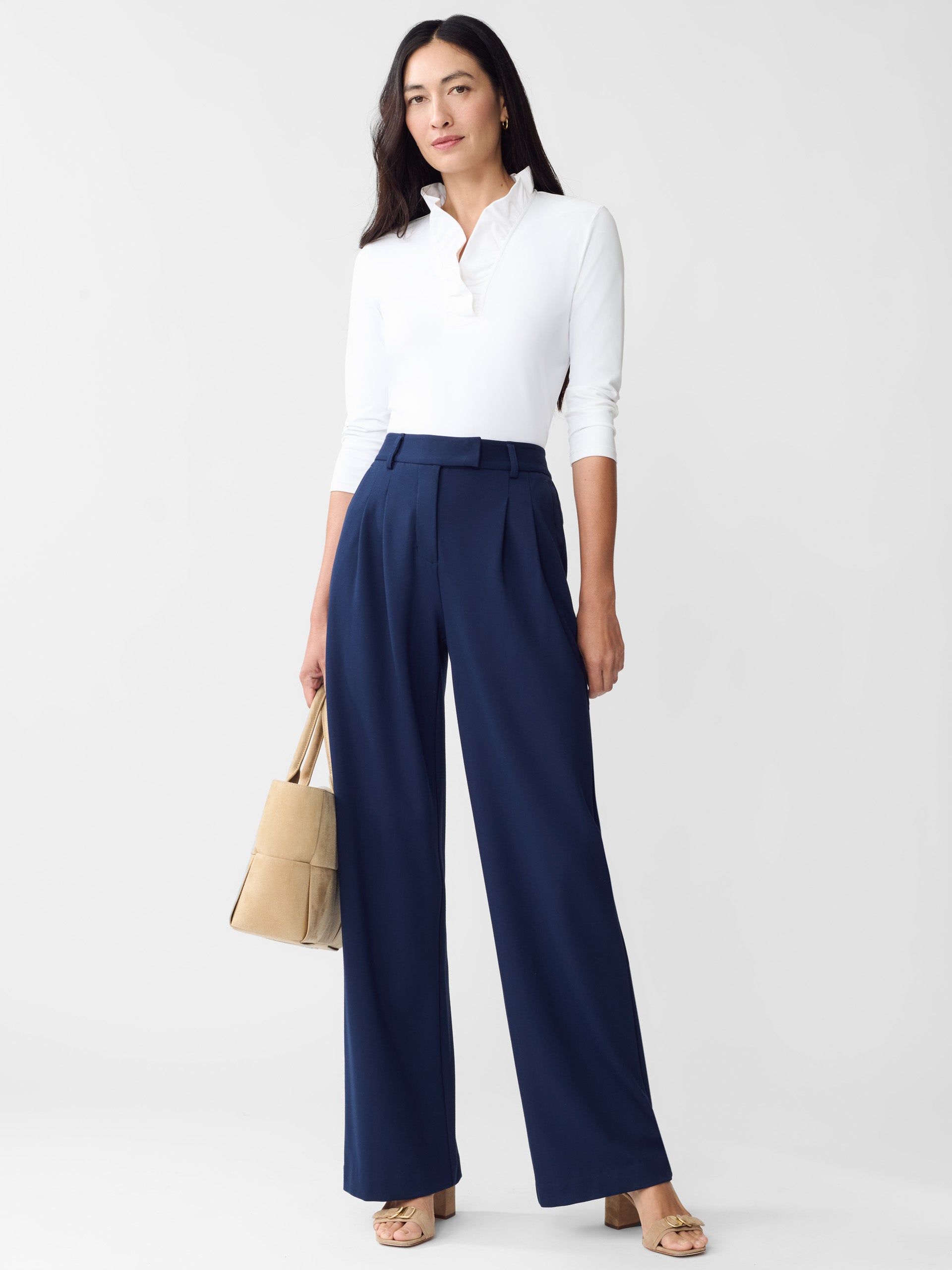 Model wearing J.McLaughlin Newman pants in winter navy made with rayon/nylon/spandex.