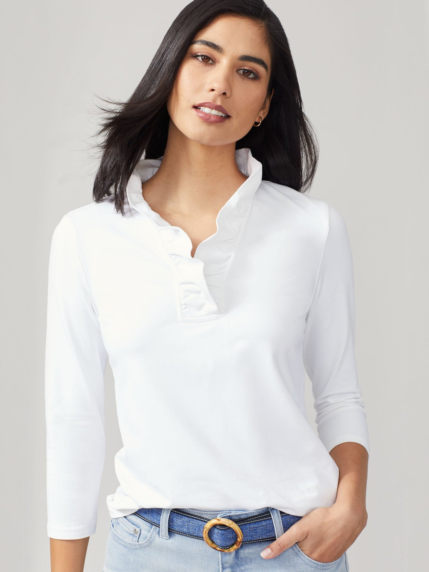 Model wearing J.McLaughlin Durham ruffle top in white made with Catalina cloth.