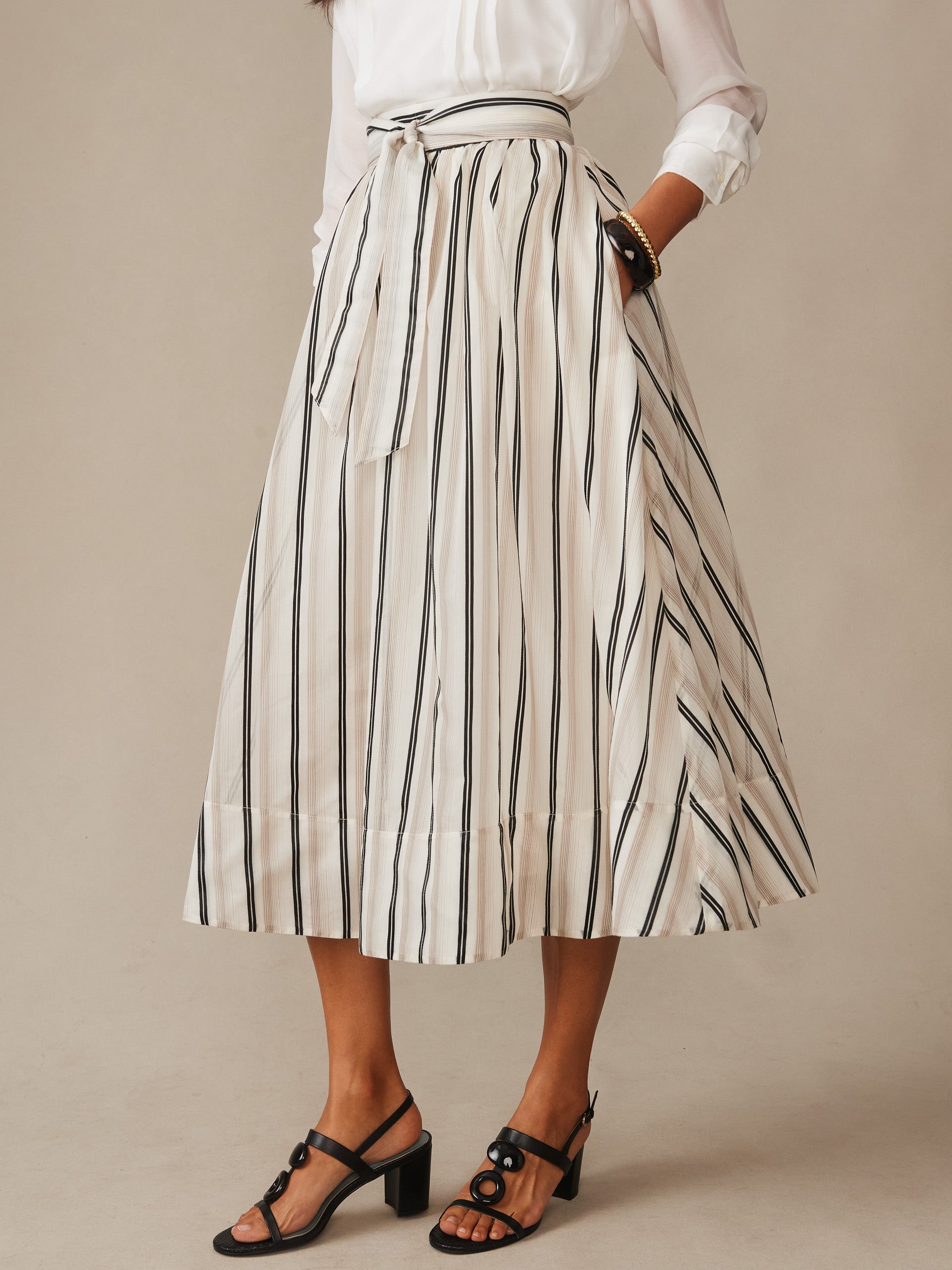 Elenia Skirt in Stripe from J.McLaughlin features effortlessly stylish vertical stripes and a tied waist for a classic, enduring design in innovative fabrics, perfect for Life, Well-Lived.