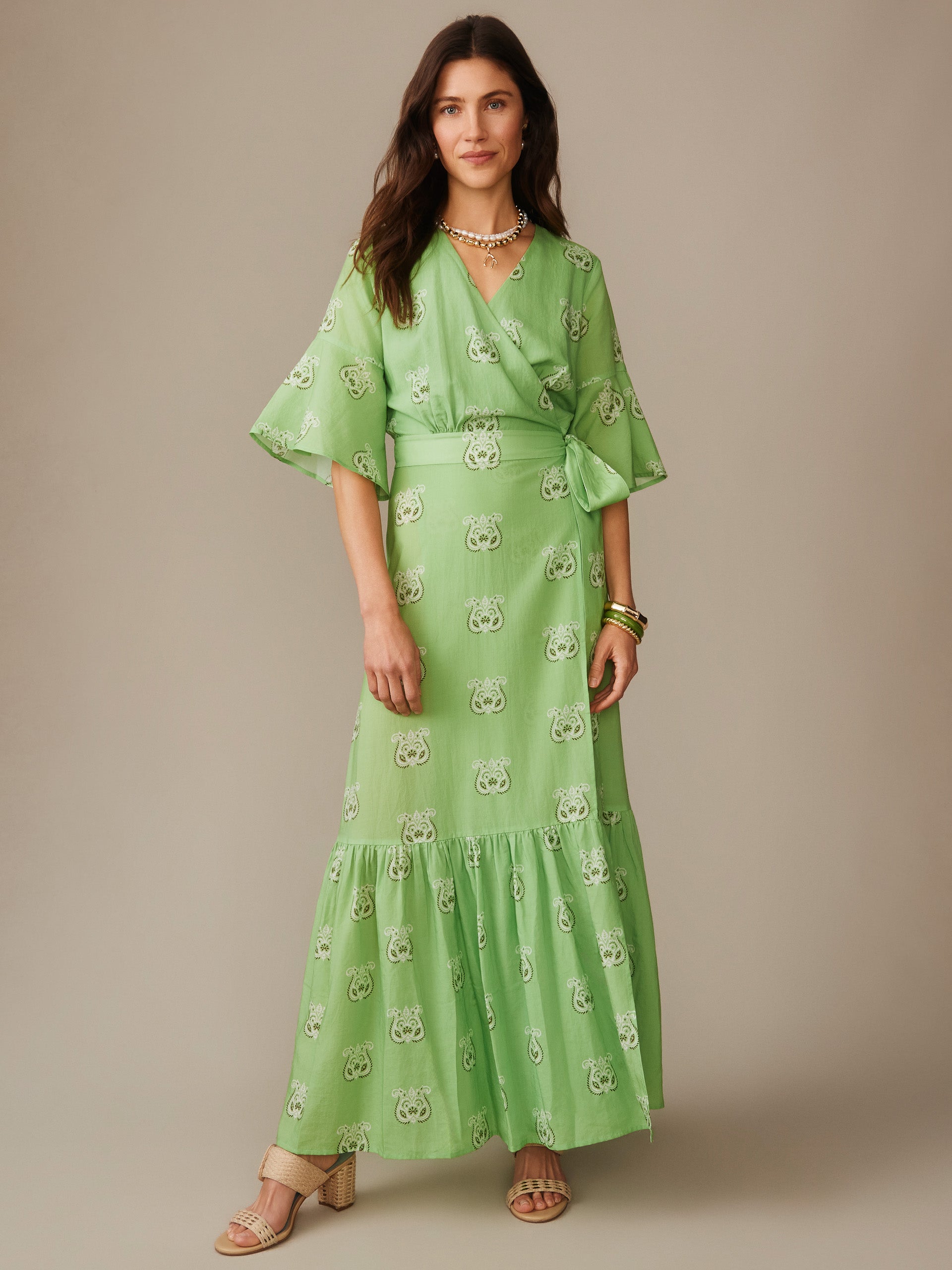 Woman wearing an effortlessly stylish Emily Wrap Dress in Siesta by J.McLaughlin, featuring enduring designs and innovative fabrics that reflect a legacy of timeless fashion. A destination for defining style. Life, Well-Lived.
