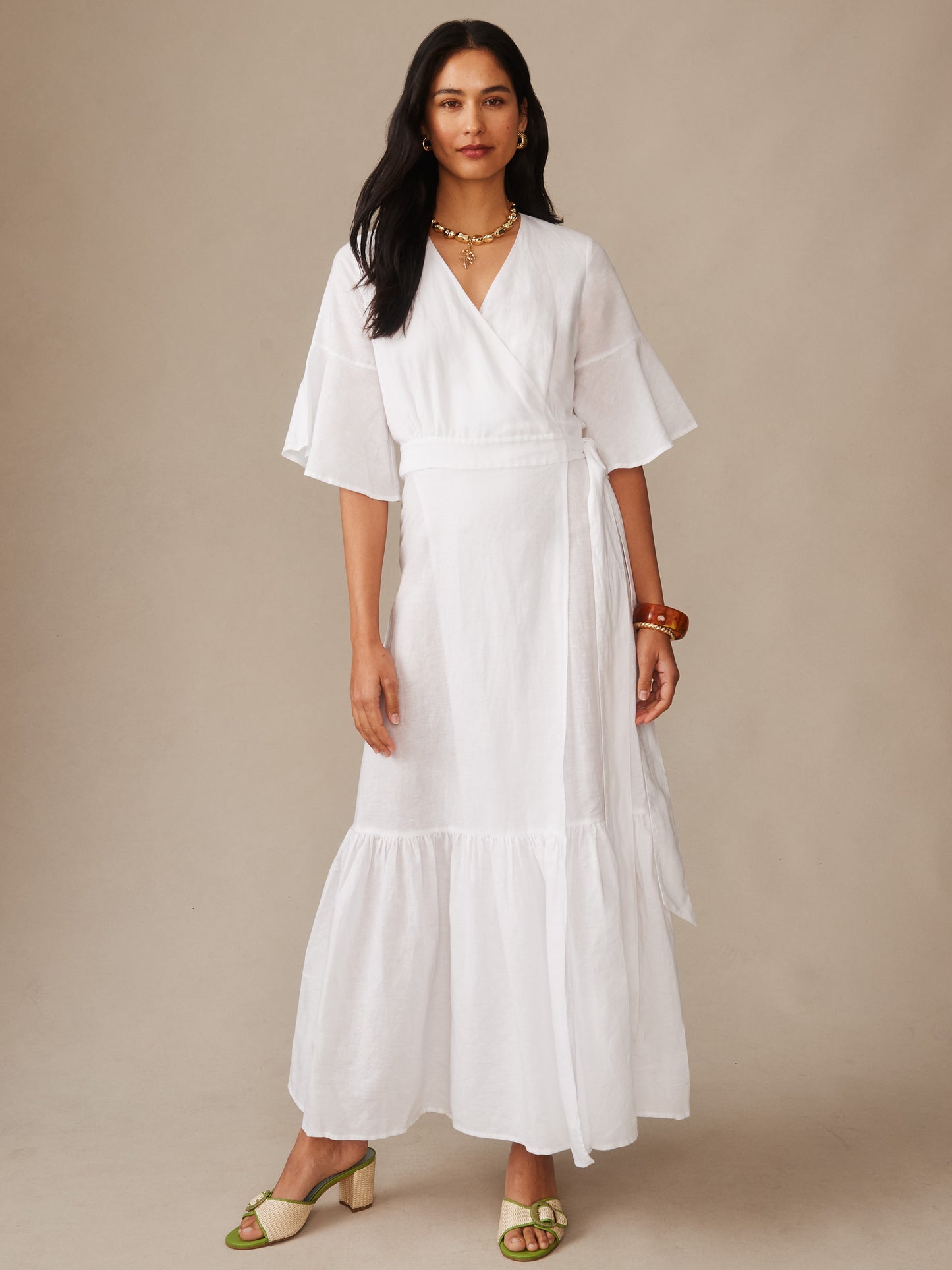 A model wearing the Emily Linen Blend Wrap Dress by J.McLaughlin, showcasing effortlessly stylish design and innovative fabrics, embodying enduring designs and a legacy of timeless fashion.