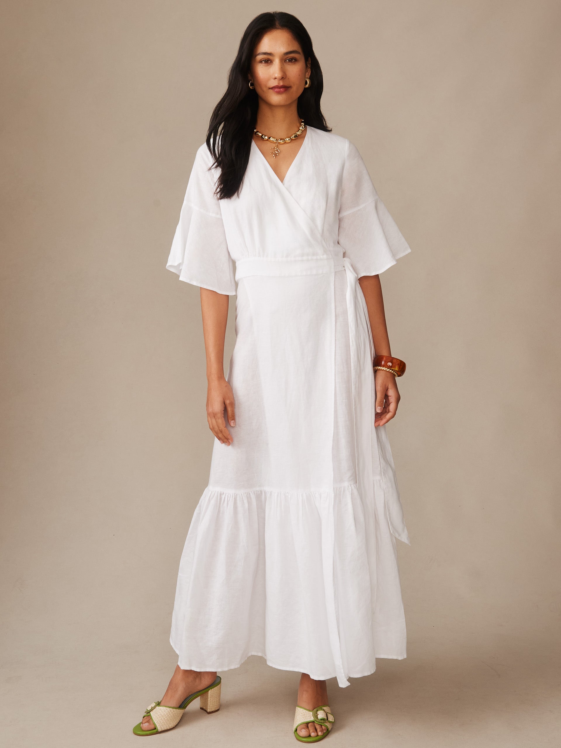 A model wearing the Emily Linen Blend Wrap Dress by J.McLaughlin, showcasing effortlessly stylish design and innovative fabrics, embodying enduring designs and a legacy of timeless fashion.