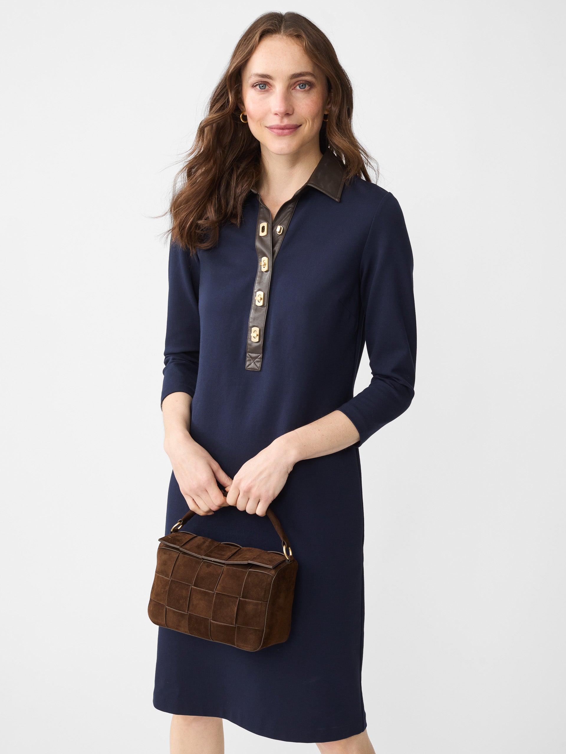 Model wearing J.McLaughlin Falcon dress in winter navy made with Bainbridge fabric.