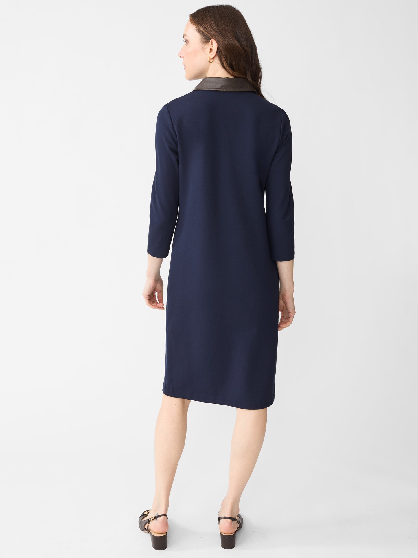 Model wearing J.McLaughlin Falcon dress in winter navy made with Bainbridge fabric.