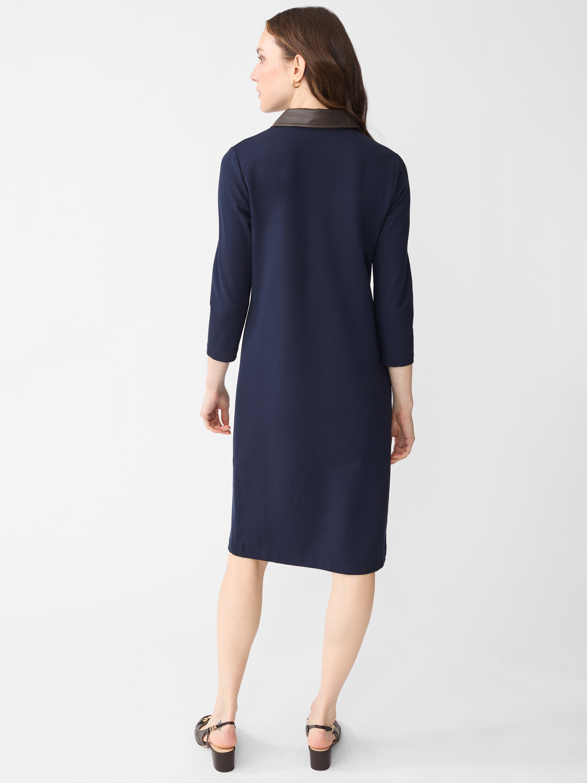 Model wearing J.McLaughlin Falcon dress in winter navy made with Bainbridge fabric.