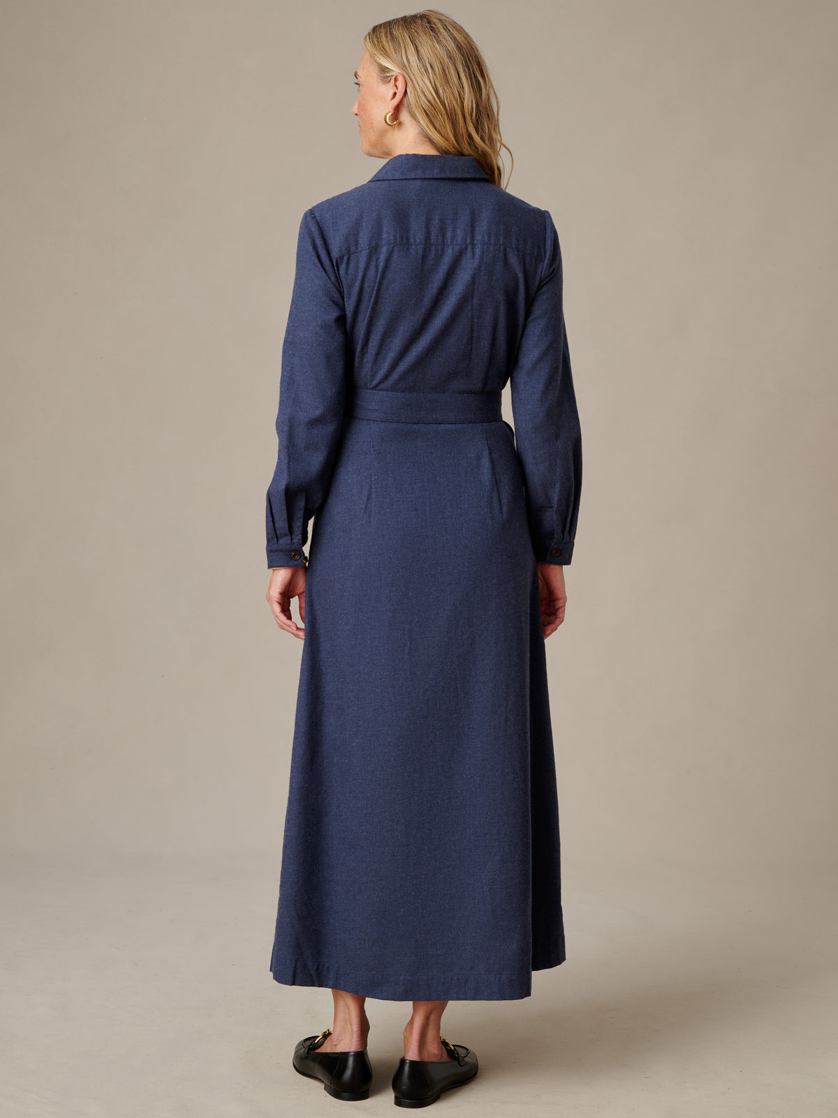 J.McLaughlin Fallon Dress in navy with long sleeves and a self belt shown from the back on a model.