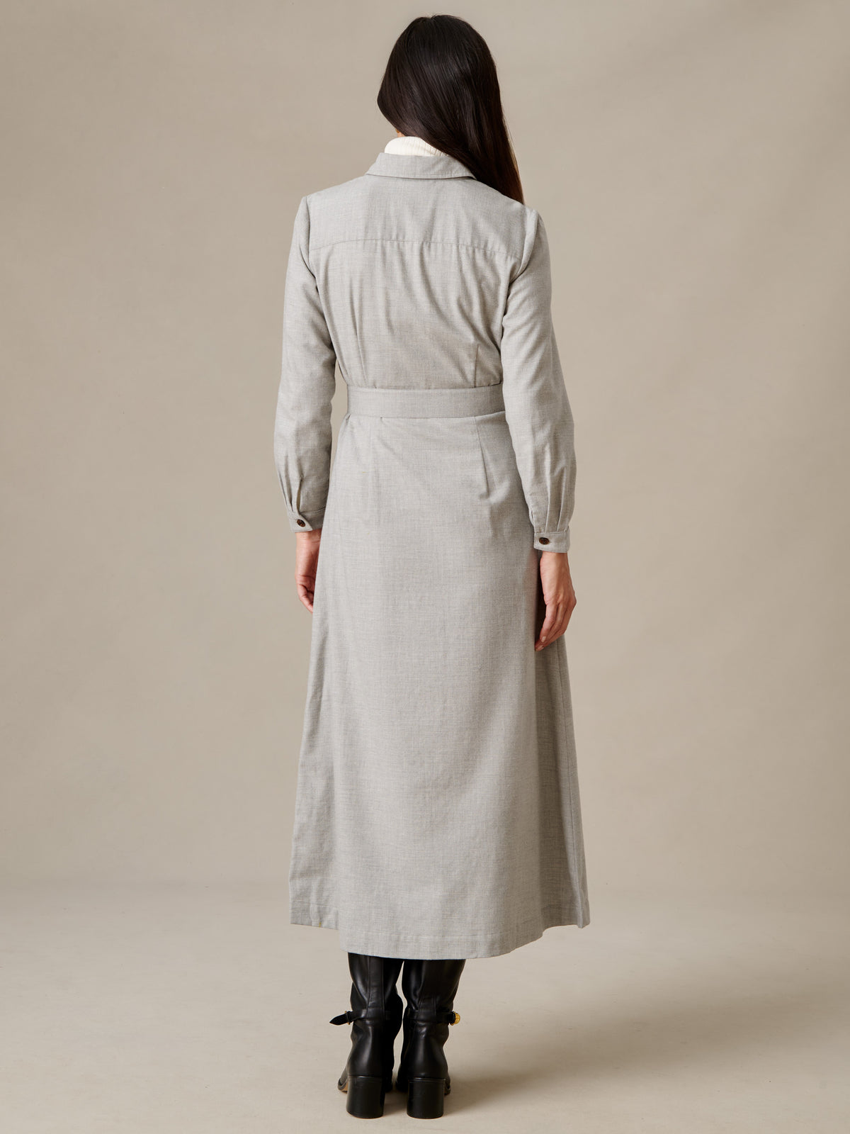 Fallon Dress by J.McLaughlin shown from the back on a model wearing a light gray belted shirt dress with long sleeves and black boots