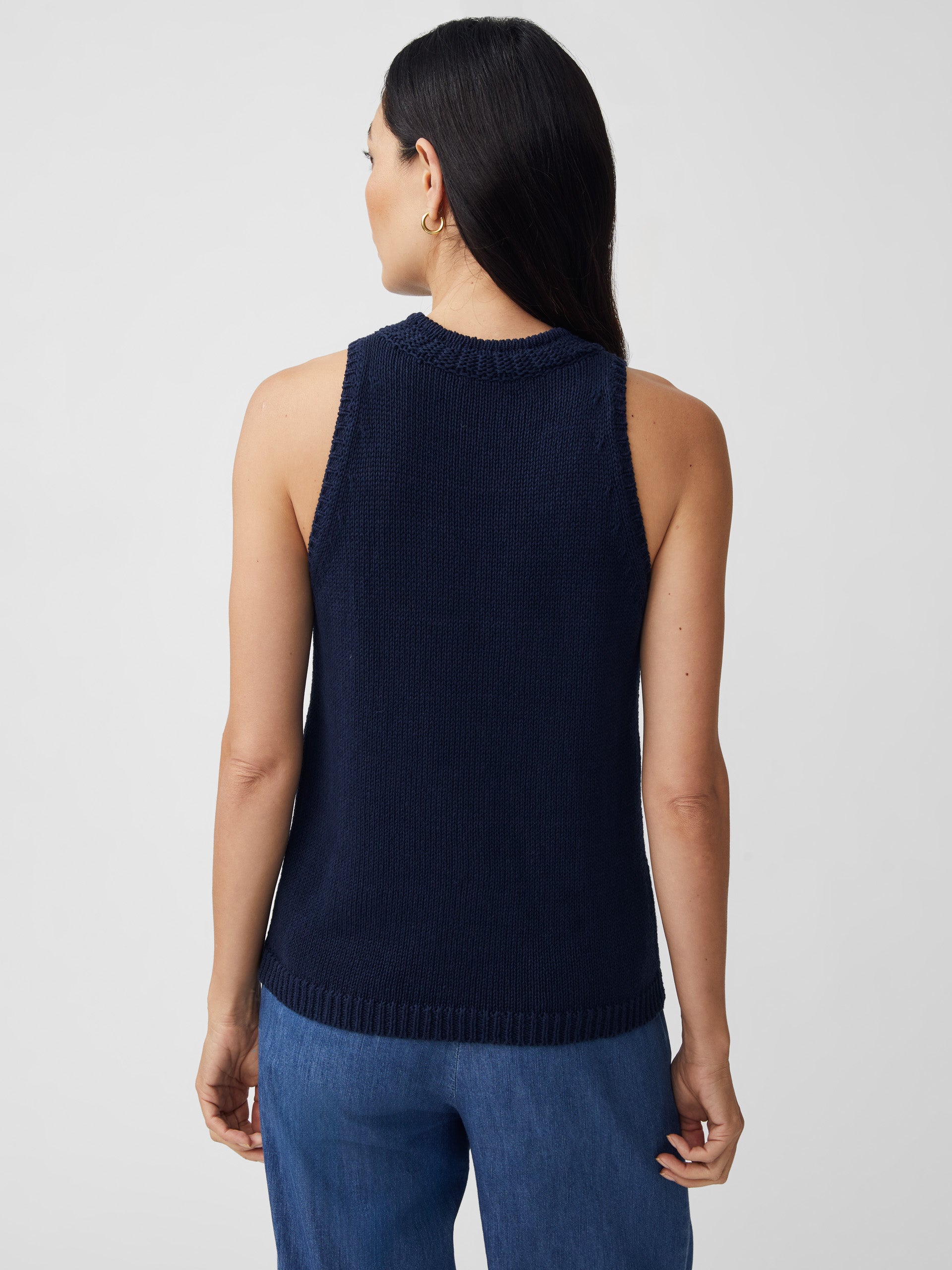 J.McLaughlin model wears Felicity Sleeveless Sweater in navy made with cotton/linen.
