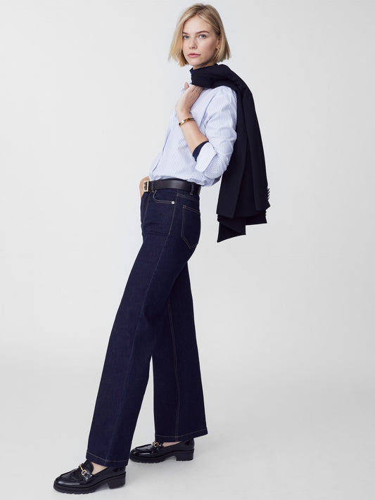 Model wearing J.McLaughlin Lowden jeans in dark denim made with woven denim.