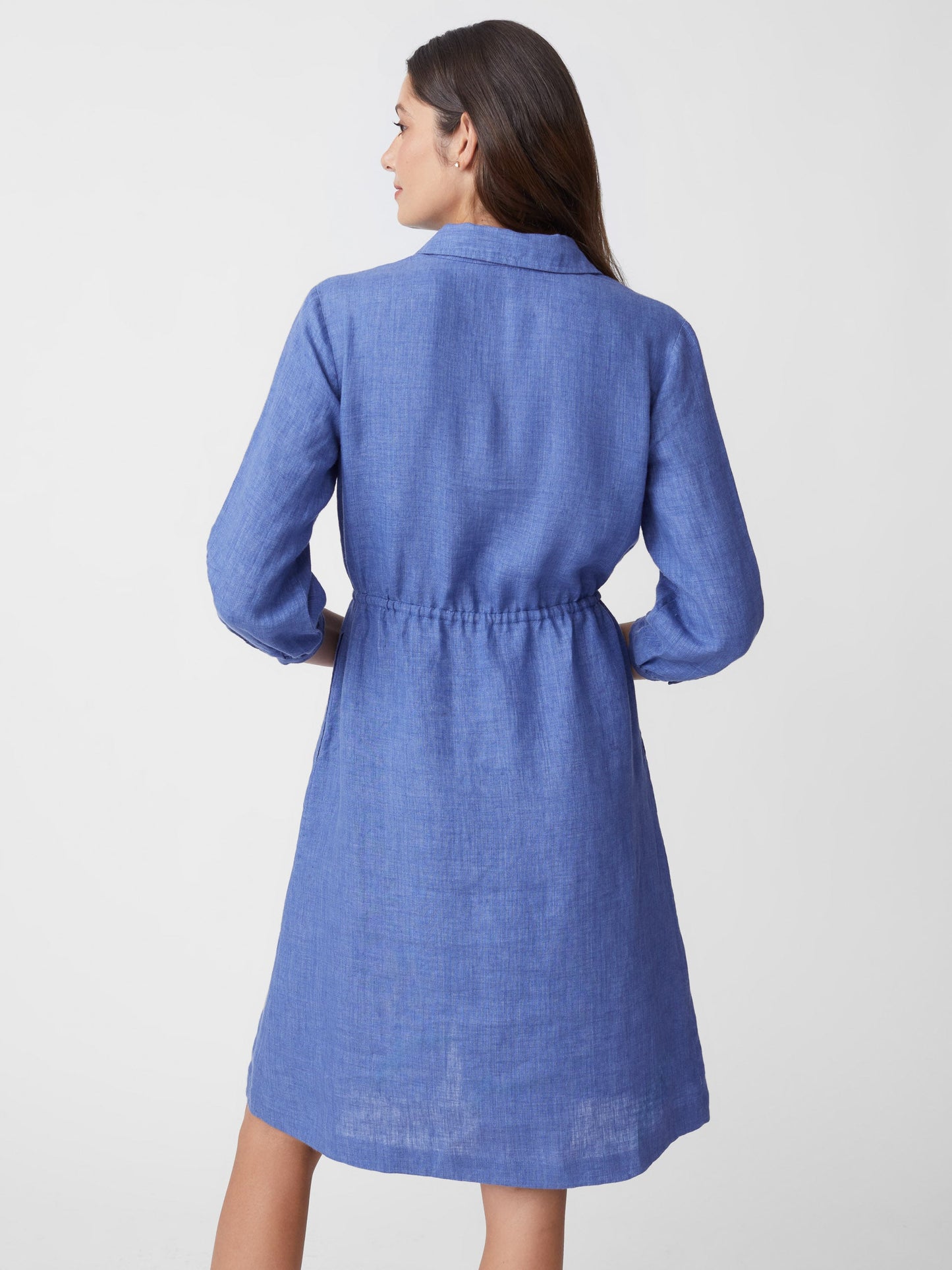 Model wears J.McLaughlin Flor Linen Dress in solid denim made with linen.