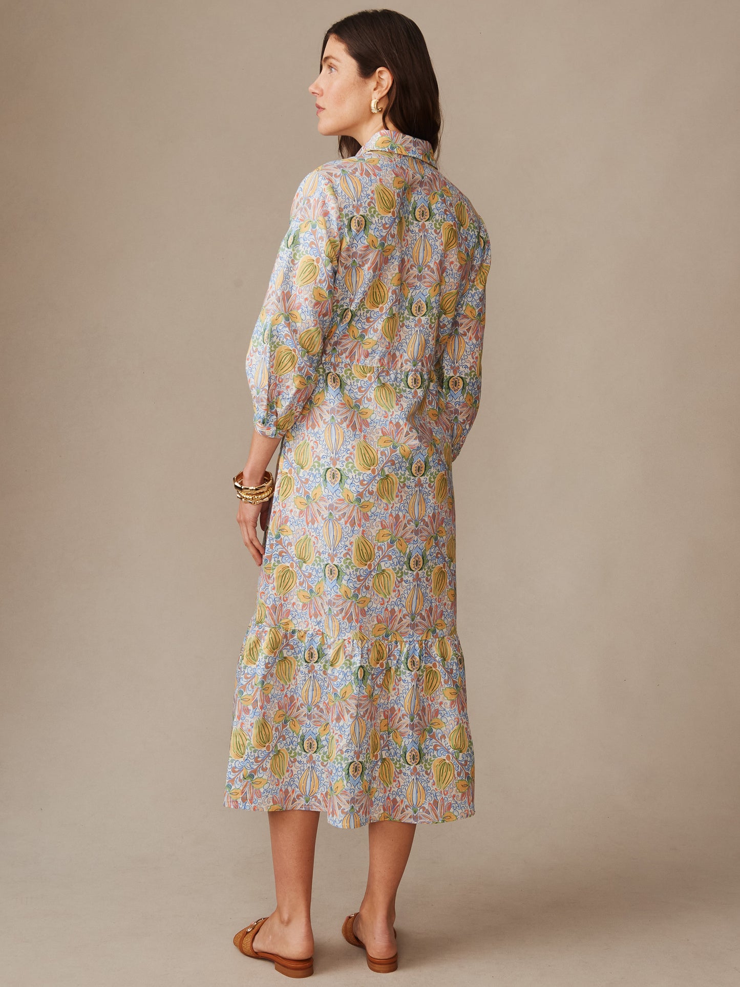 Woman wearing a Foley Linen Blend Dress in Tropico Tapestry by J.McLaughlin, featuring effortless style and enduring design in an innovative linen blend fabric, embodying a legacy of timeless fashion. A destination for defining style. Life, Well-Lived.