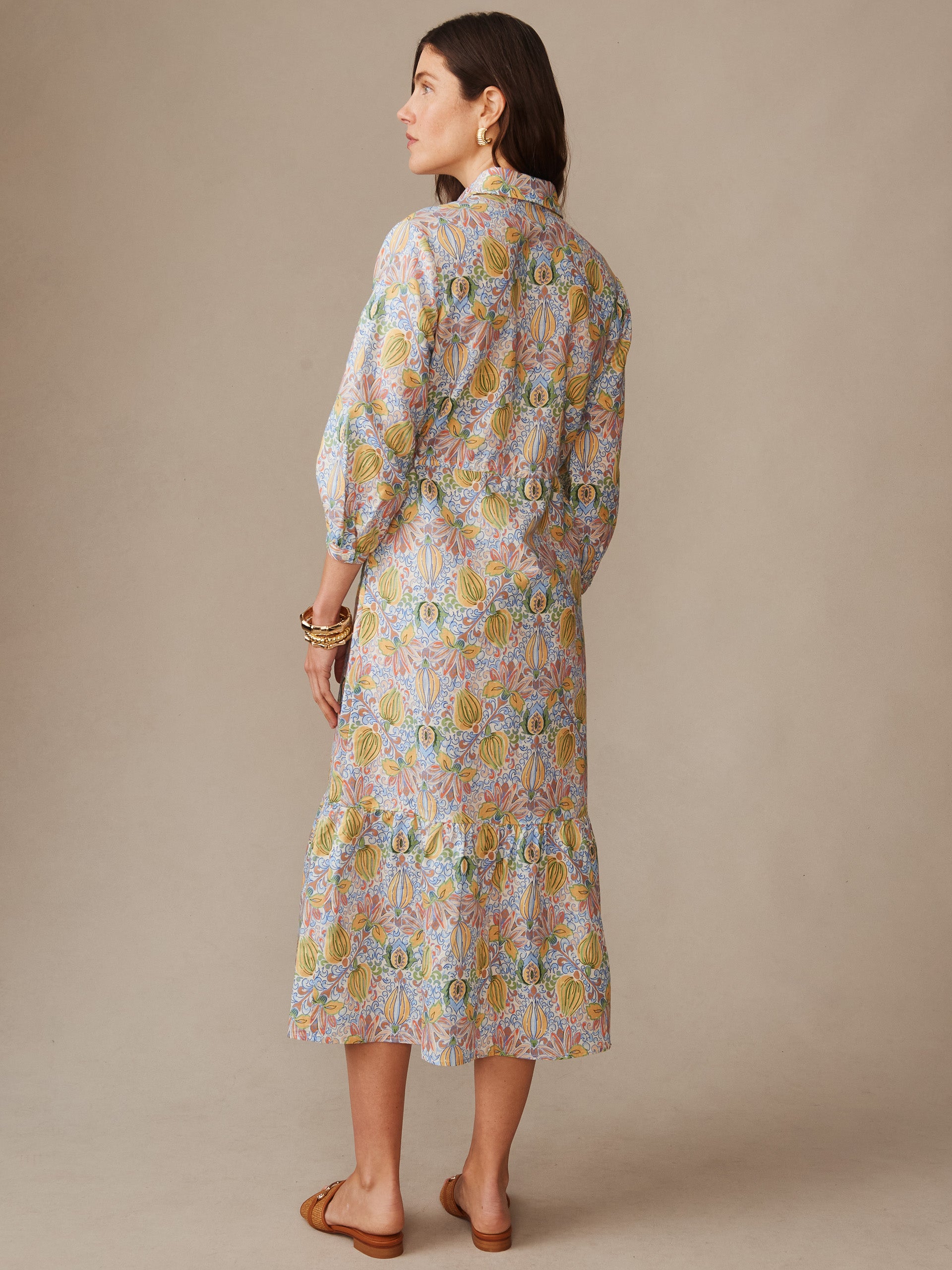 Woman wearing a Foley Linen Blend Dress in Tropico Tapestry by J.McLaughlin, featuring effortless style and enduring design in an innovative linen blend fabric, embodying a legacy of timeless fashion. A destination for defining style. Life, Well-Lived.