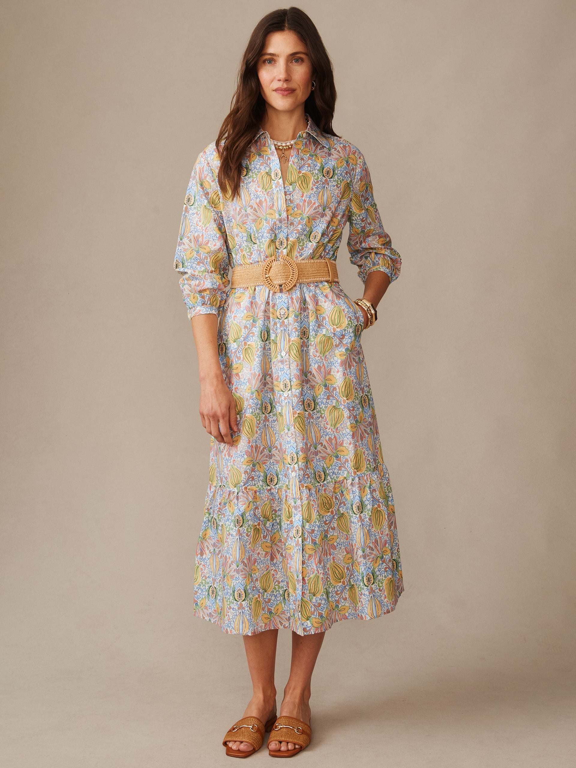 Woman wearing a Foley Linen Blend Dress in Tropico Tapestry by J.McLaughlin, featuring a floral pattern, belted waist, and styled with sandals for an effortlessly stylish look.