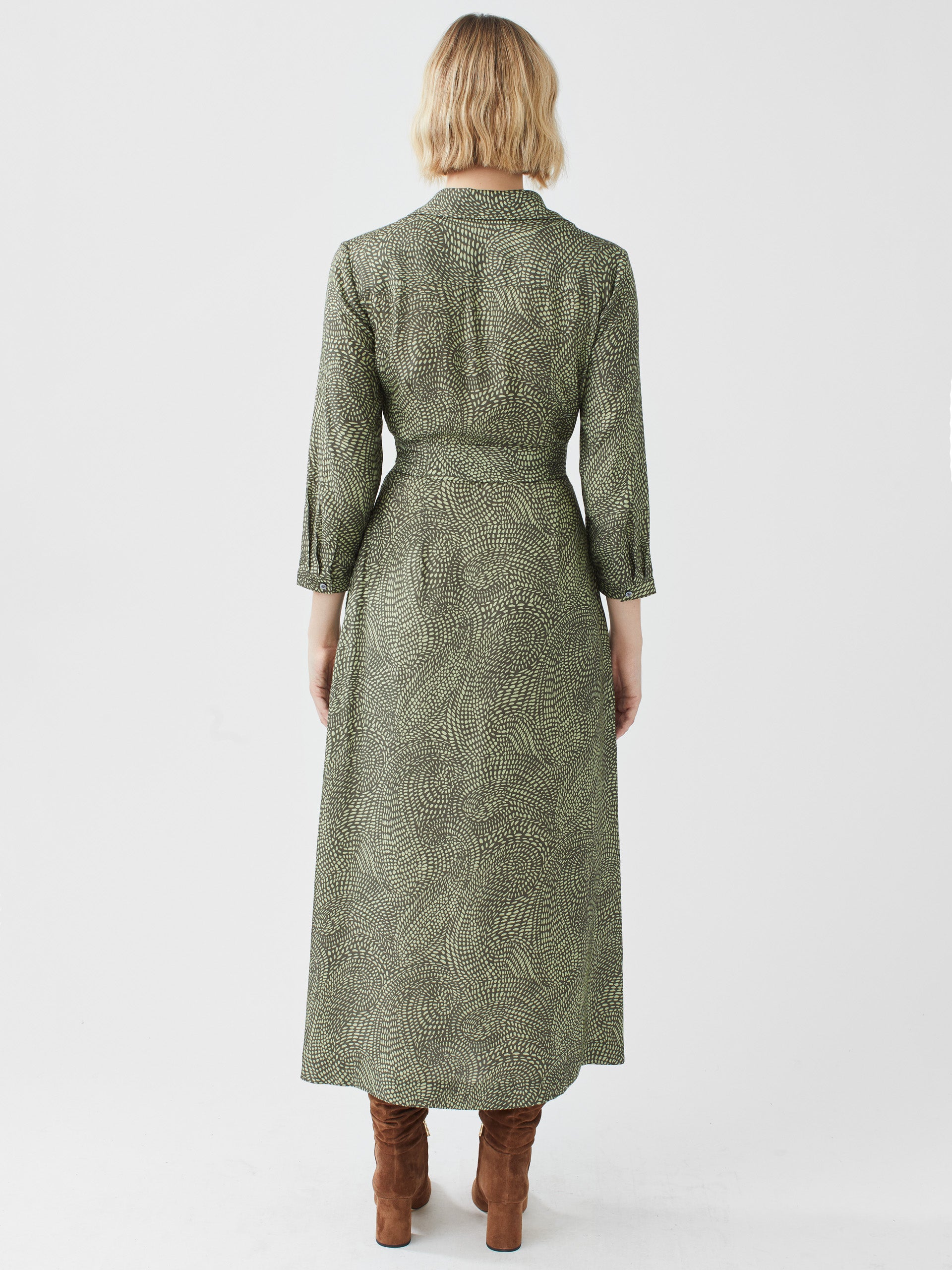 Model wearing J.McLaughlin Freda dress in olive/green made with viscose and silk.