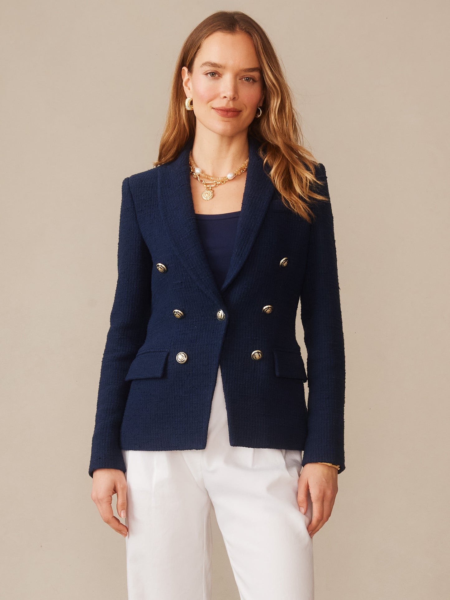 A woman models the Genevieve Cotton Bouclé Blazer by J.McLaughlin in navy, featuring double-breasted silver buttons and tailored design, reflecting effortlessly stylish, enduring designs with innovative fabrics from a destination for defining style. Life, Well-Lived.
