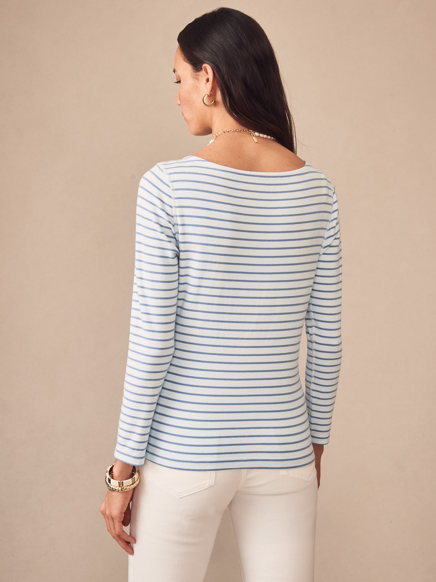 Woman wearing J.McLaughlin Goldie Tee in Stripe with light blue and white stripes, showcasing effortless style and enduring design in high-quality fabric. A destination for defining style. Life, Well-Lived.