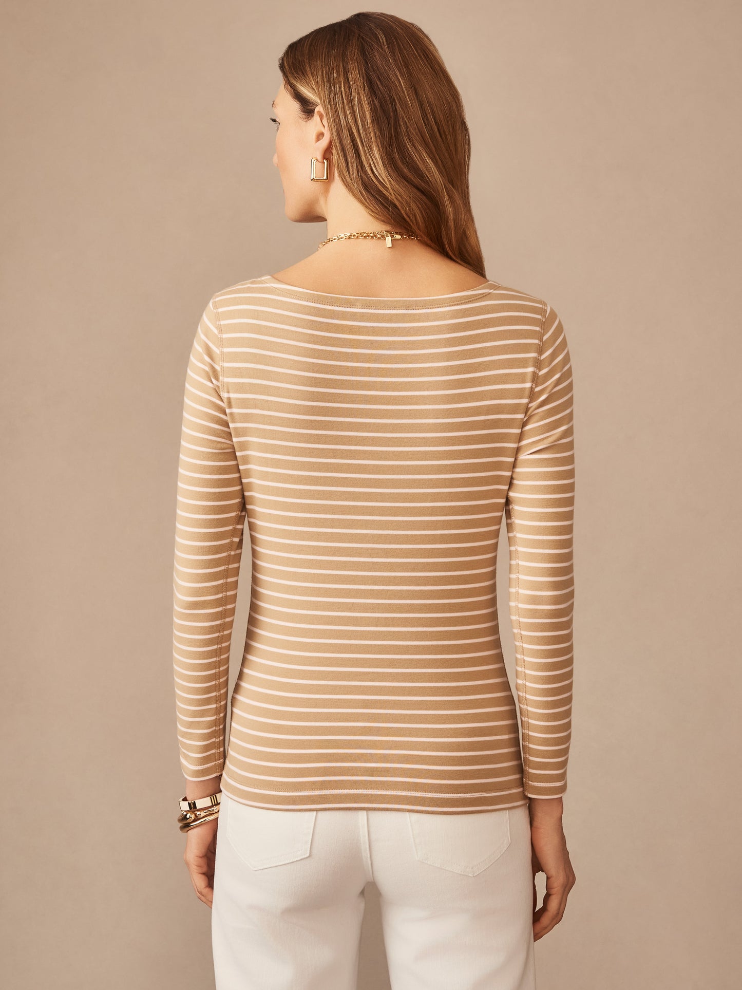 Back view of a woman wearing the Goldie Tee in Stripe by J.McLaughlin, featuring khaki and pink horizontal stripes in an effortlessly stylish design that reflects enduring designs and innovative fabrics in a legacy of timeless fashion. A destination for defining style. Life, Well-Lived.