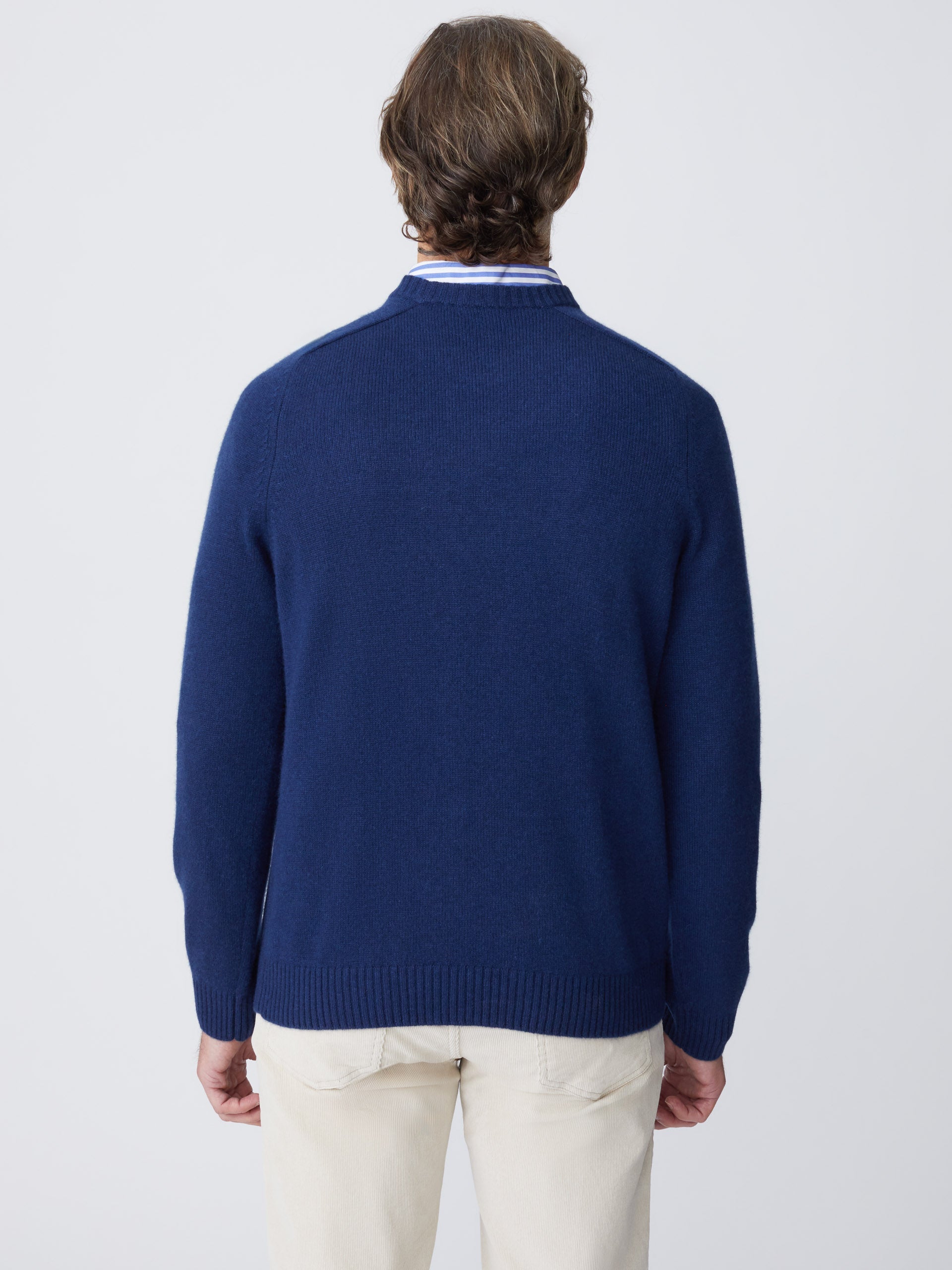 Model wears J.McLaughlin Gordon sweater in classic navy made with cashmere.